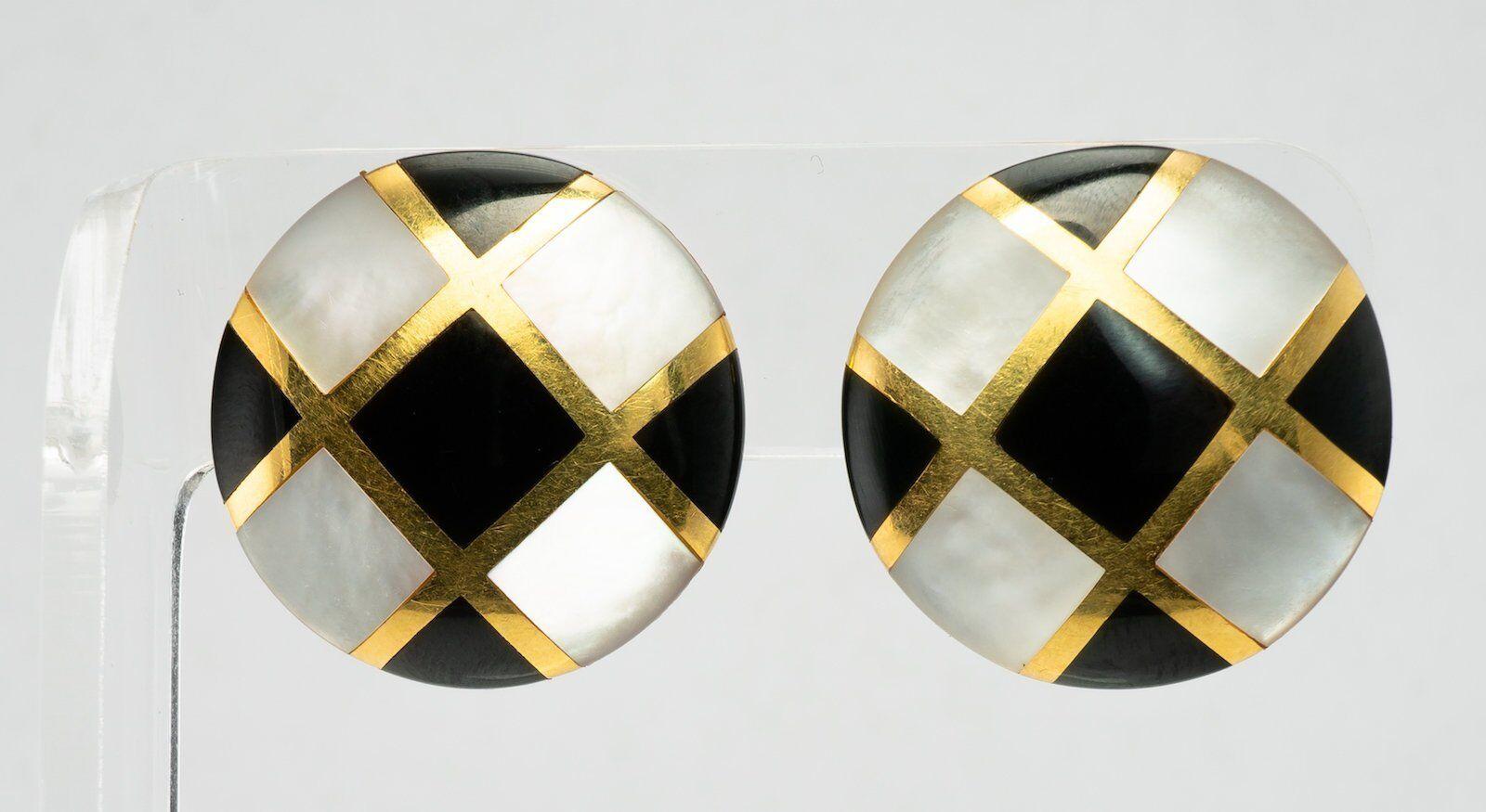 This hard to find authentic Tiffany & Co. earrings are finely crafted in solid 18K Yellow Gold (stamped).
Each earring is inlaid with genuine Black Onyx and Mother of Pearl. 
The earrings measure 26mm x 5mm thick. They are equipped with long posts