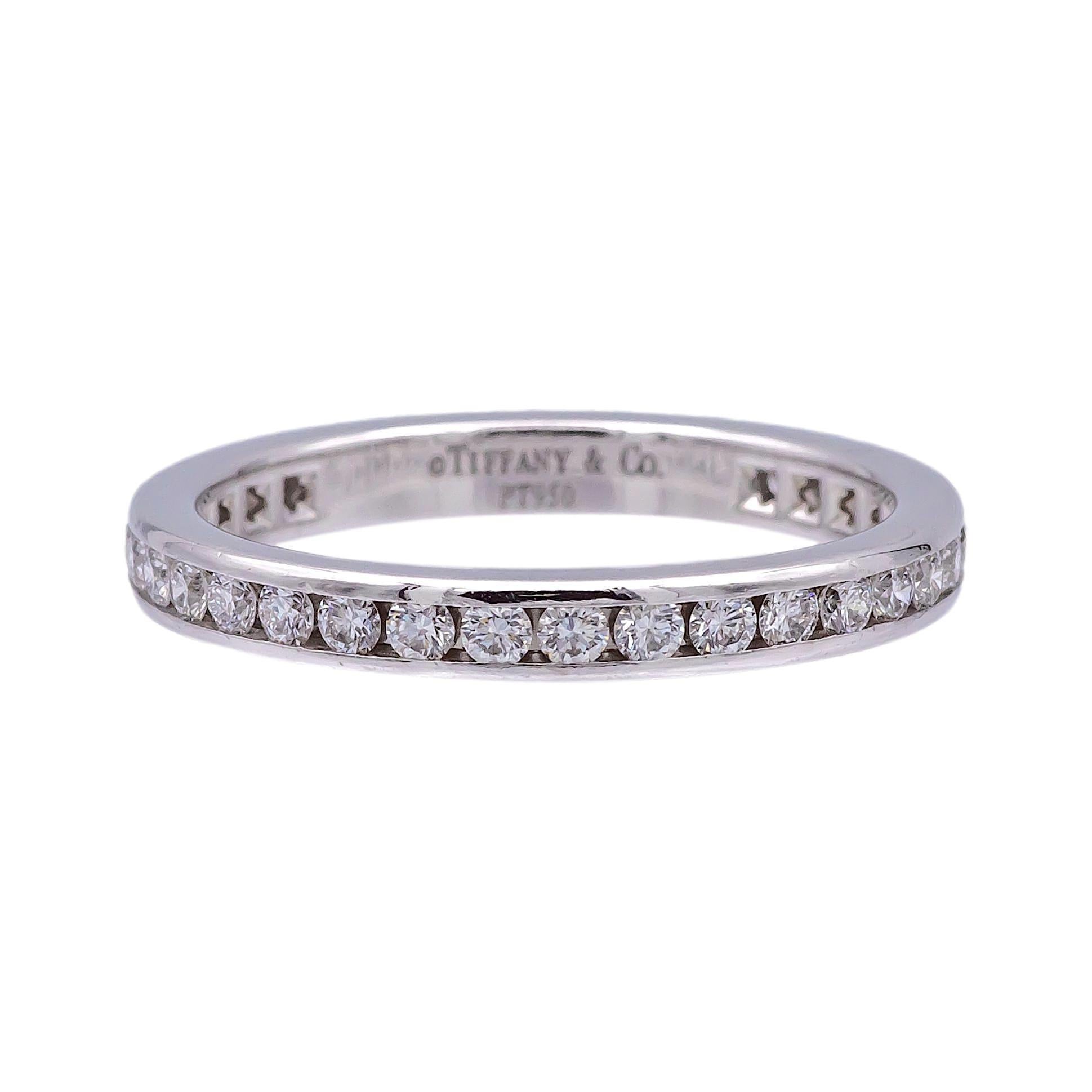 Tiffany & Co. wedding band finely crafted in platinum with 34 round brilliant cut diamonds weighing 0.56 carats total weight approximately set all the way around in a channel setting. The ring is 2.5 mm wide.  Fully hallmarked with logo and metal