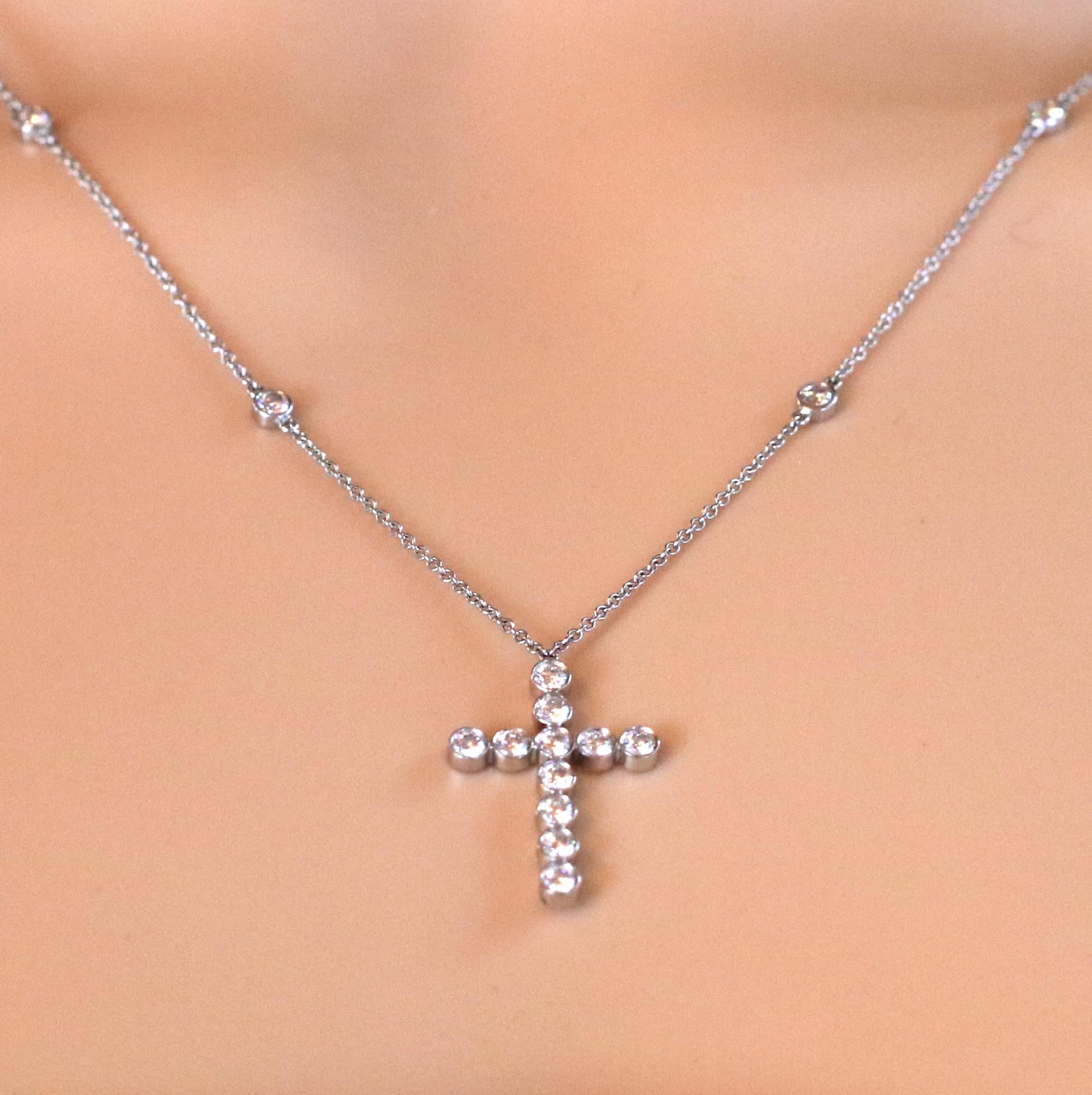 A ladies platinum necklace with platinum and diamond cross and 20 inch platinum cable link neck chain, set with 10 round brilliant cut diamonds in bezels. At the bottom of this beautiful piece is a platinum cross comprised of 11 bezel set diamonds.