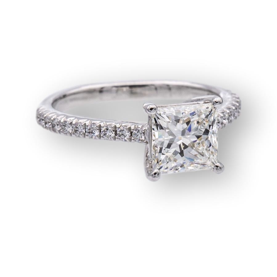 Tiffany & Co. engagement ring from the Novo collection finely crafted in platinum featuring a princess cut brilliant diamond center weighing 1.09 carats , H color , VVS2 clarity set in a 4 prong basket setting adorned with 16 bead set round