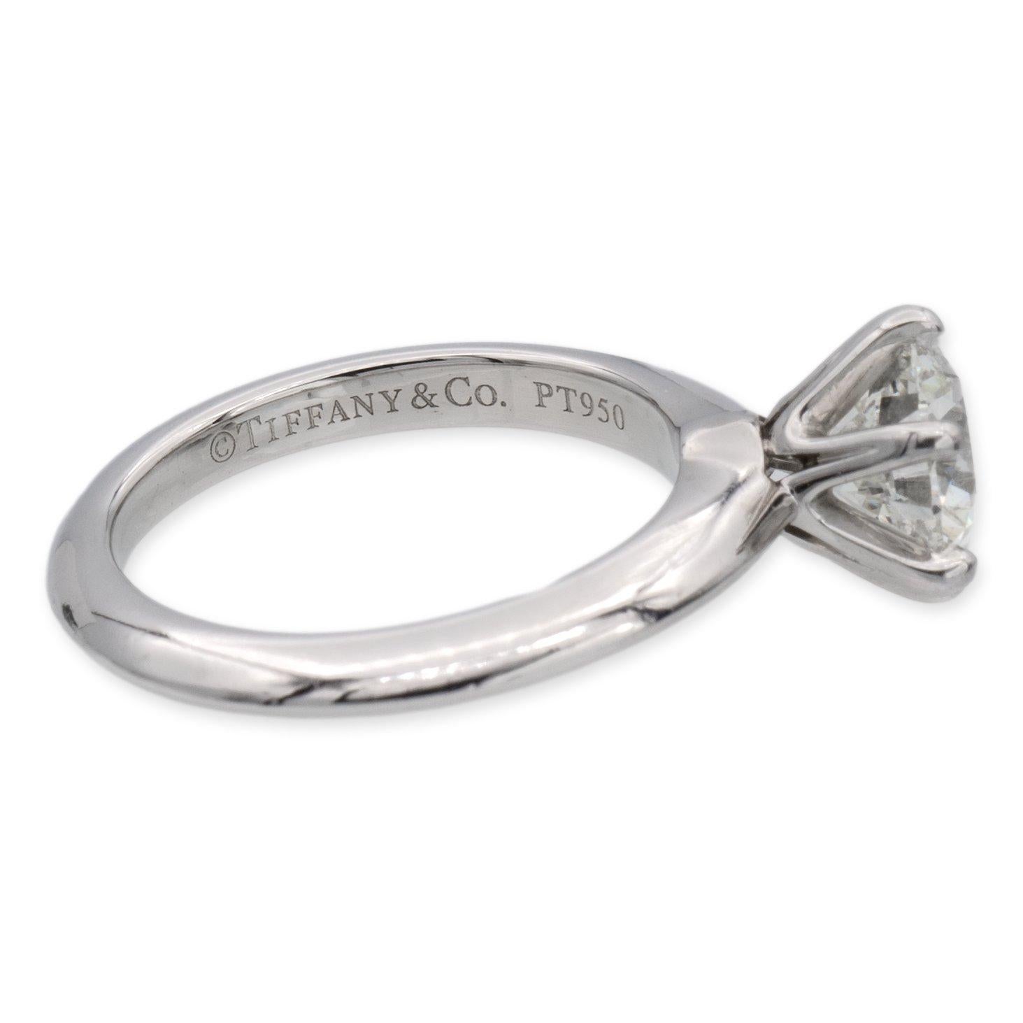 Tiffany & Co. Solitaire diamond engagement ring finely crafted in a six prong platinum mounting featuring a 1.04 carat round brilliant diamond center graded I color and VS1 Clarity. The diamond is inscribed with Tiffanys serial numbers and has