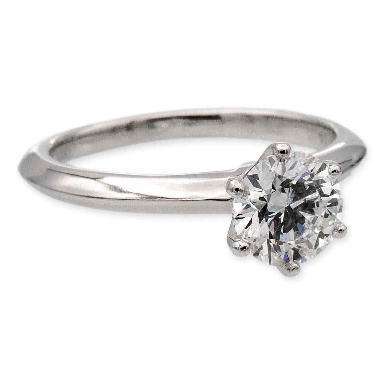 Tiffany & Co. Solitaire diamond engagement ring finely crafted in a six prong platinum mounting featuring a 1.14 carat round brilliant diamond center graded G color and VS2 Clarity. The diamond is inscribed with Tiffanys serial numbers and has
