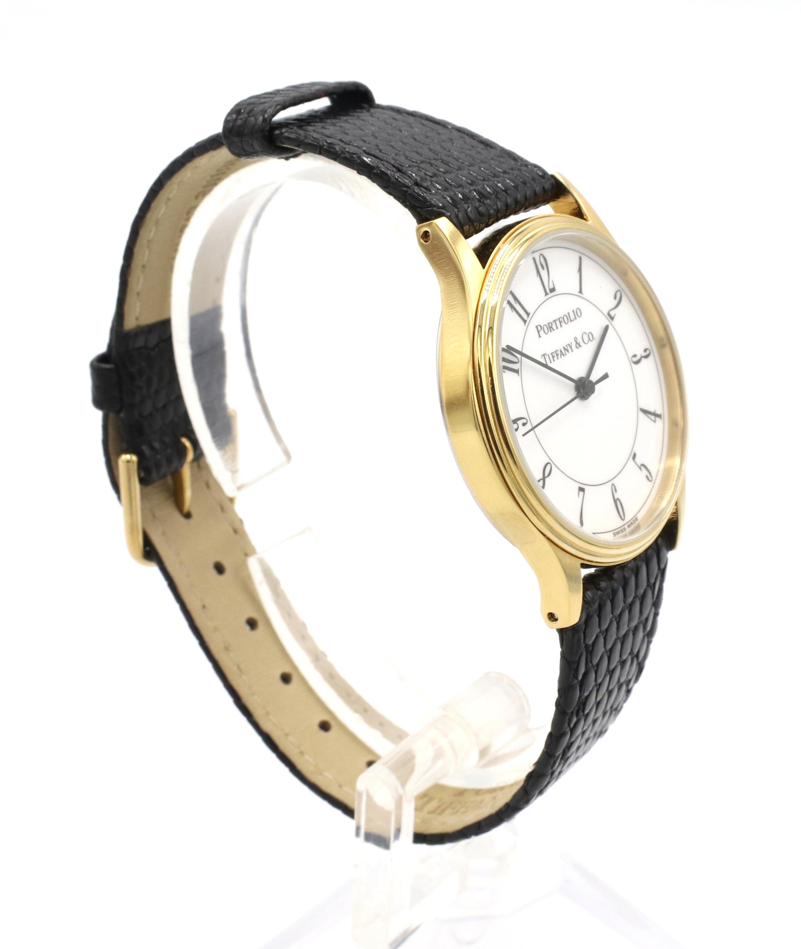 Tiffany and Co. Portfolio White Dial Black Leather Strap Quartz Watch

Case material: Gold plated and stainless steel
Dial: White
Movement: Quartz
Case size: 32mm
Strap: Genuine Lizard Leather, Black, Tiffany & Co
Band width: 18
Water resistant: 10