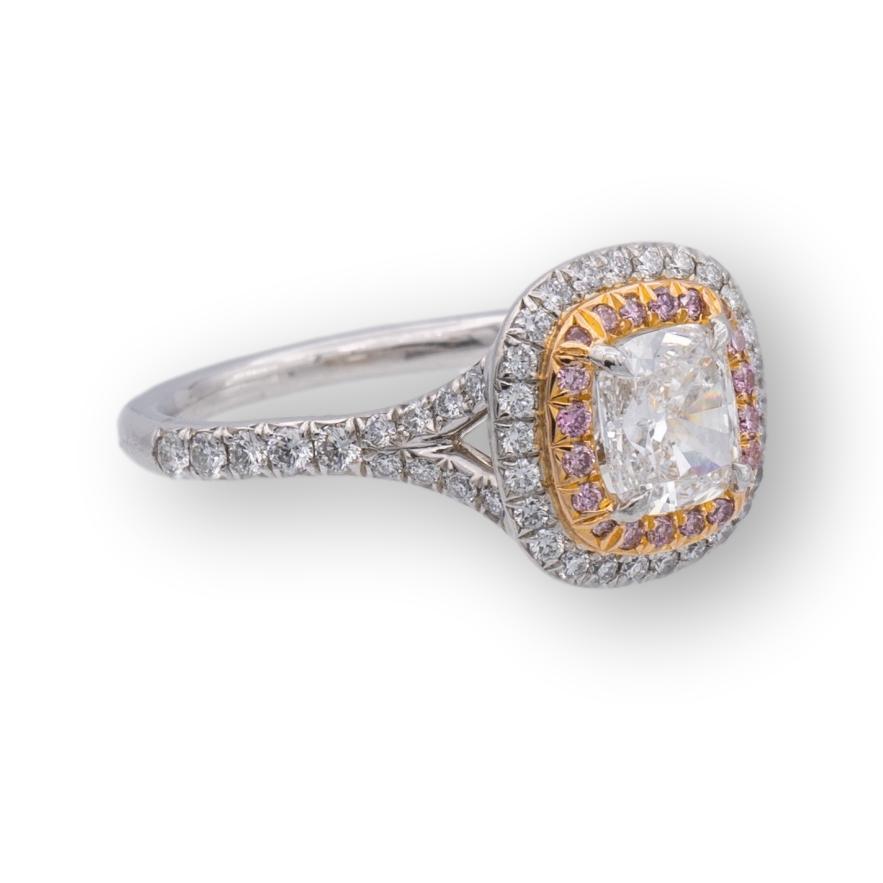 Tiffany & Co. engagement ring from the Soleste collection finely crafted in platinum with a .81 ct cushion center , F Color, VVS2 clarity accented by a double row halo design with one row featuring round brilliant cut bead set fancy pink diamonds