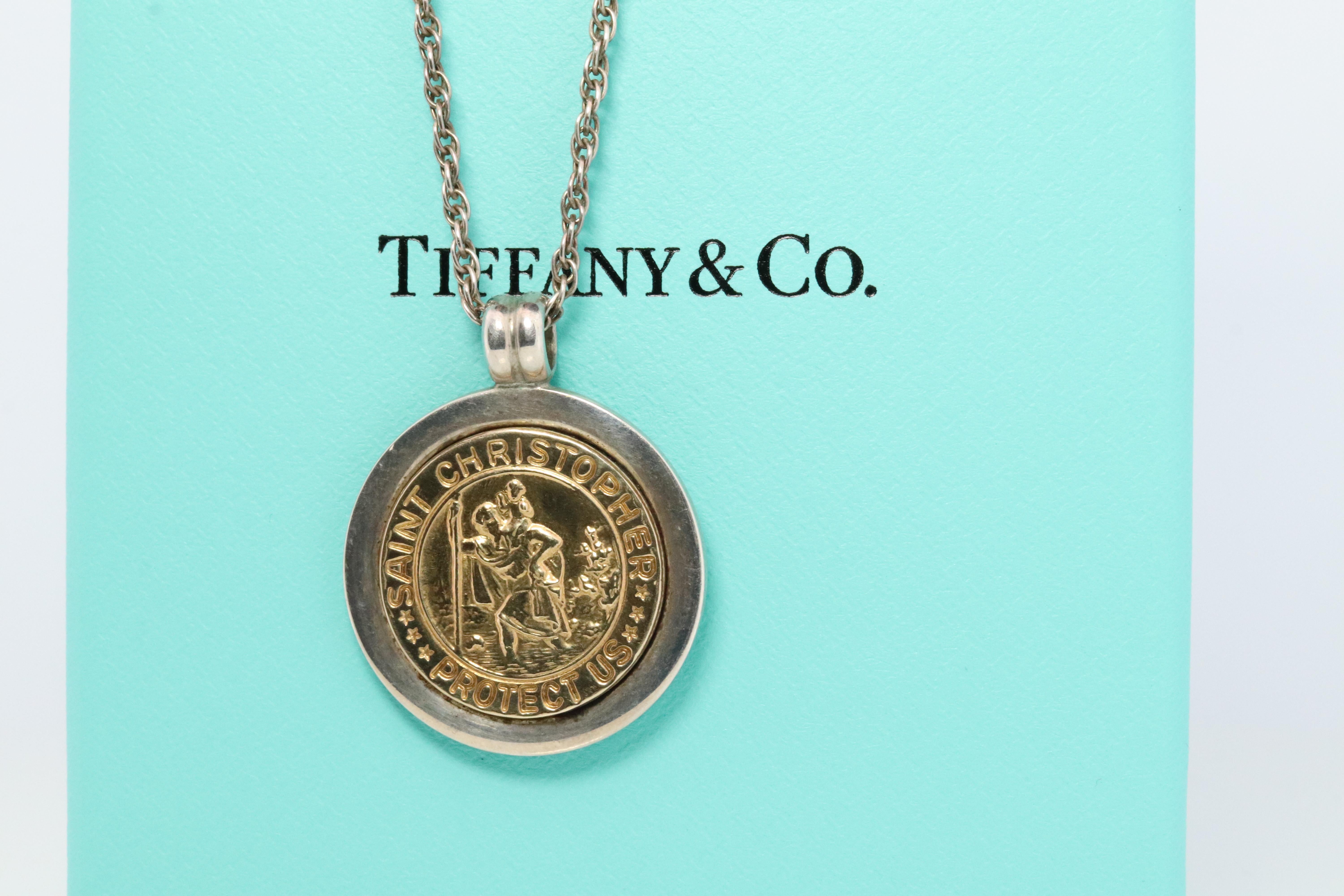 Genuine Tiffany and Co.  Pendant

Saint Christopher Protect Us Medallion

18k Yellow Gold With Sterling Silver.

Minor signs of wear. 

25mm Medallion
18in sterling silver necklace
Comes with Tiffany Blue Pouch.