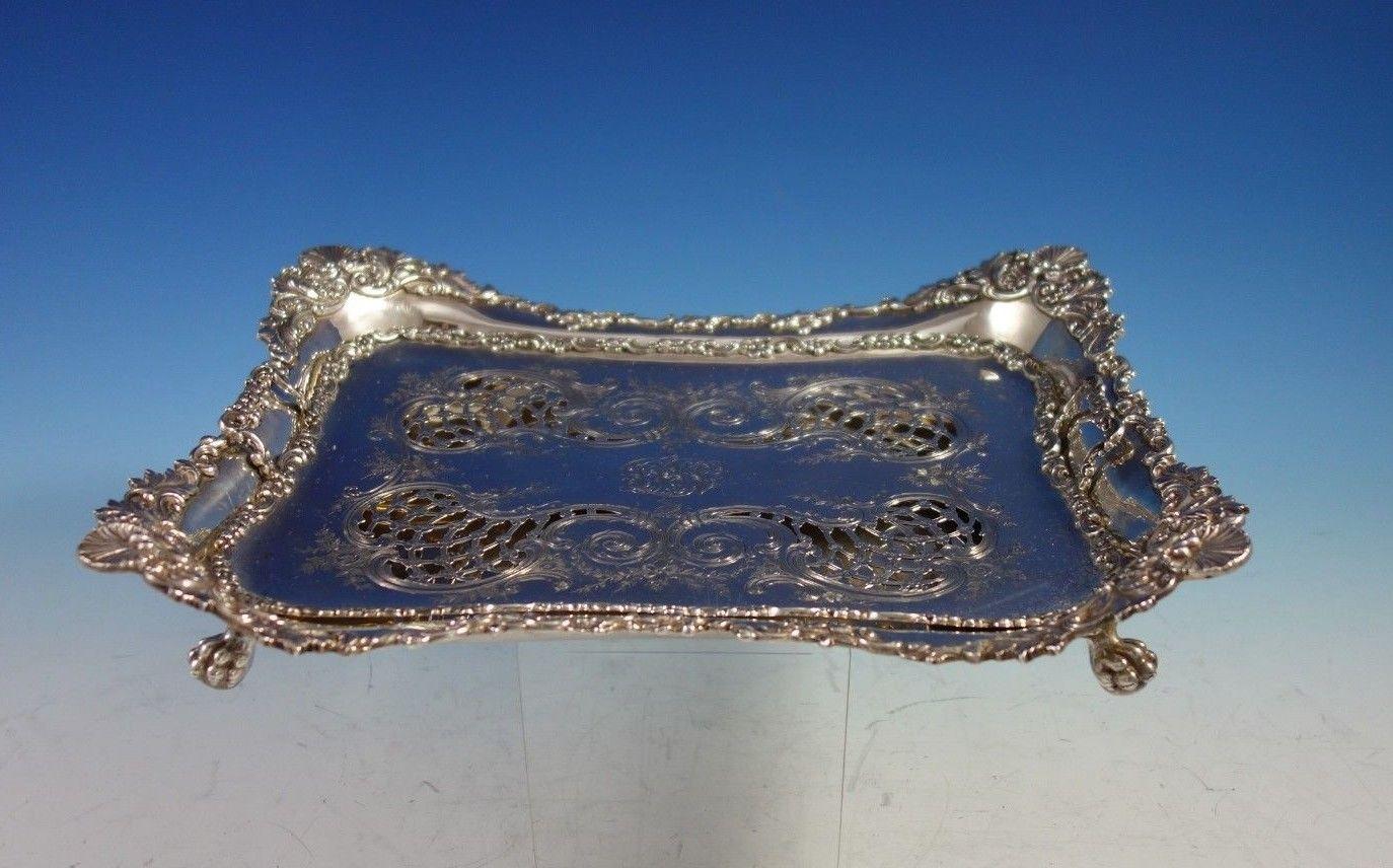 Exceptional Tiffany & Co. sterling silver asparagus tray that includes a pierced insert. This tray has a beautiful shell and flower motif. The insert is hand engraved with flowers and scrollwork.
This piece is marked #8386/6241. The tray measures 12