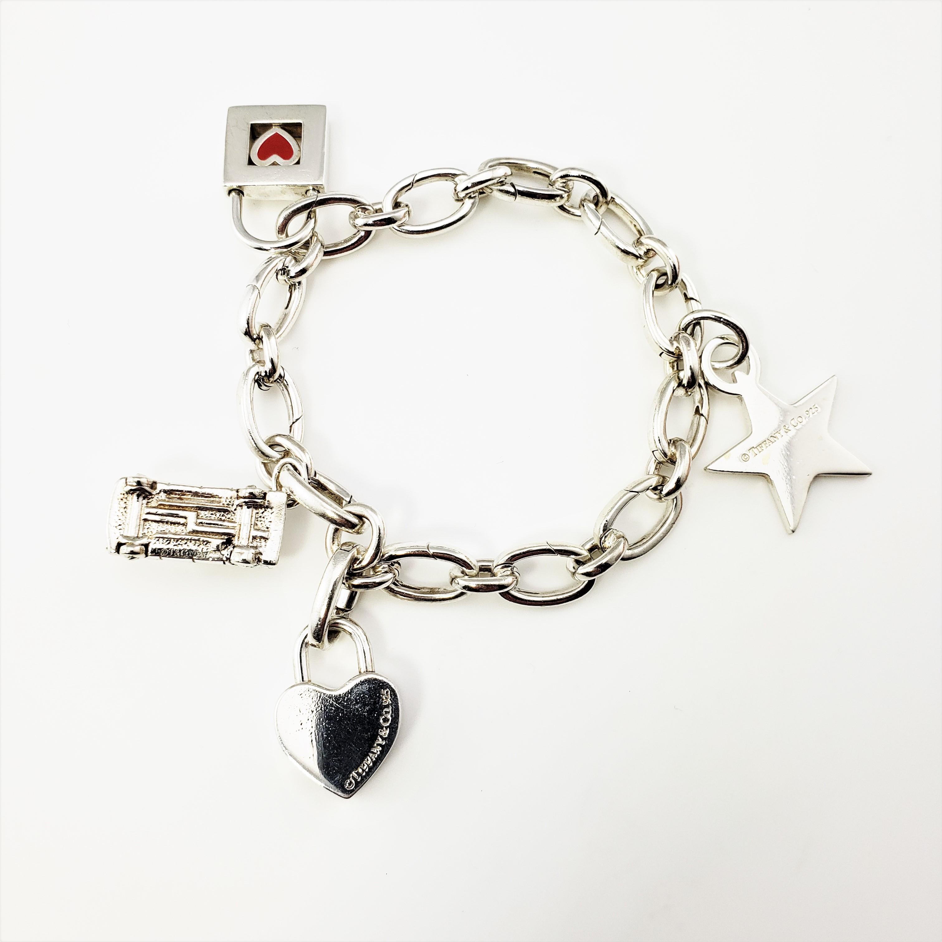 Vintage Tiffany and Co. Sterling Silver Charm Bracelet

This lovely keepsake features four charms; a star, a heart, a taxicab, and a lock suspended from an elegant link bracelet. Crafted in beautifully detailed sterling silver by Tiffany and