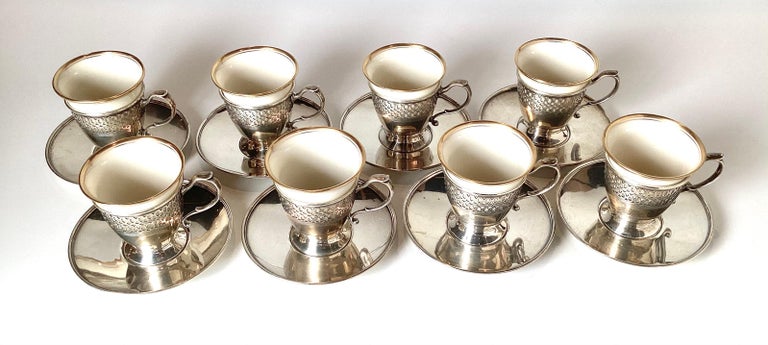 Elegant service for eight sterling silver demitasses cups and saucers by Tiffany and Co. The sterling cup holders with saucers each with a porcelain insert by lenox.