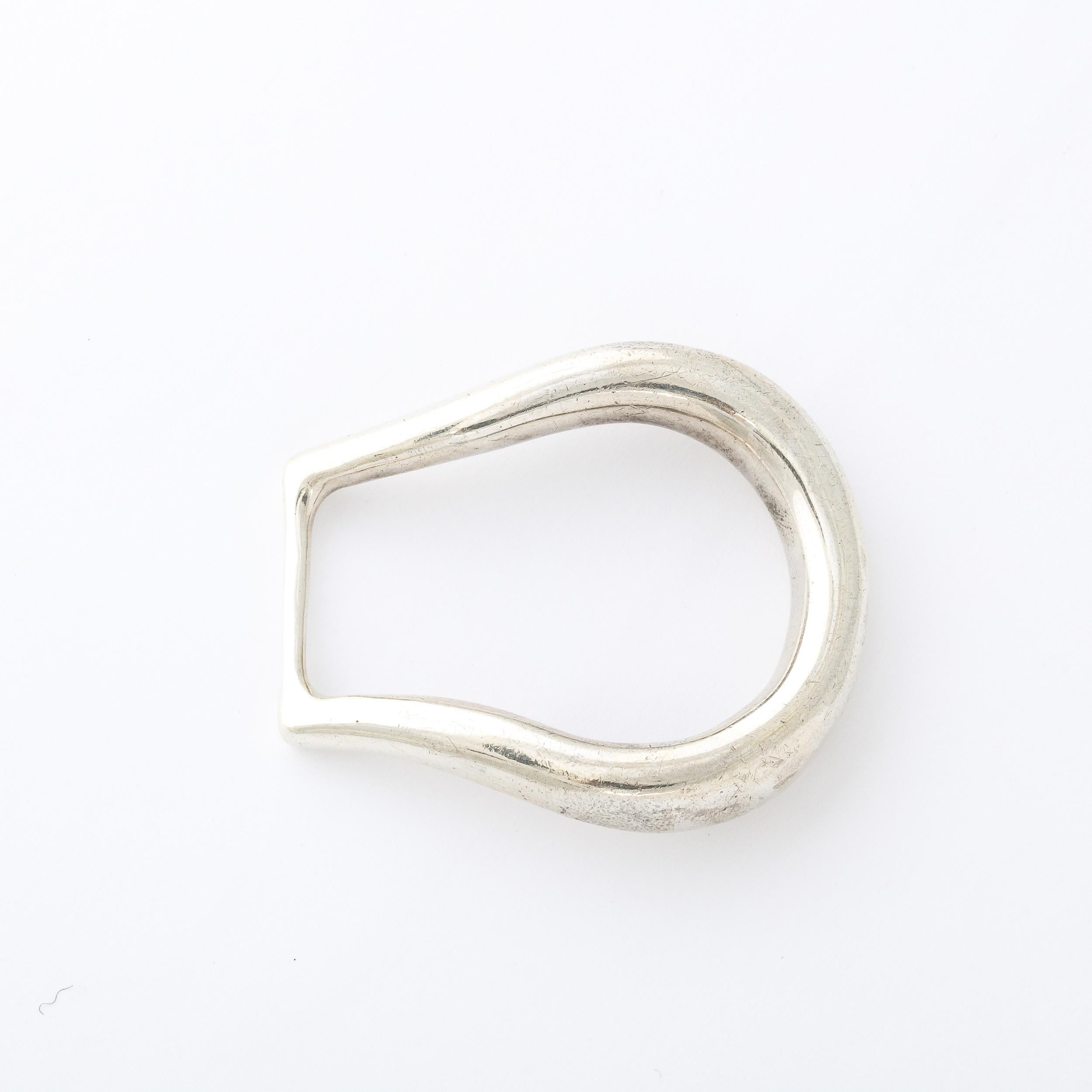 This Tiffany and Co. Sterling Silver Belt buckle is a lovely piece, originating from the United States during the latter half of the 20th Century. This modernist buckle is  formed with elegant simplicity. In solid sterling silver, this accessory