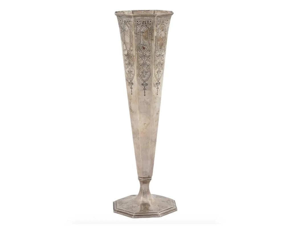 An elegant sterling silver bud vase made by Tiffany and Co. Of an octagonal shape, protruding to the upper rim and featuring delicately engraved patterns to the exterior. 

Marked to the bottom: 
Please see photos

Collectible Silverware, Luxury
