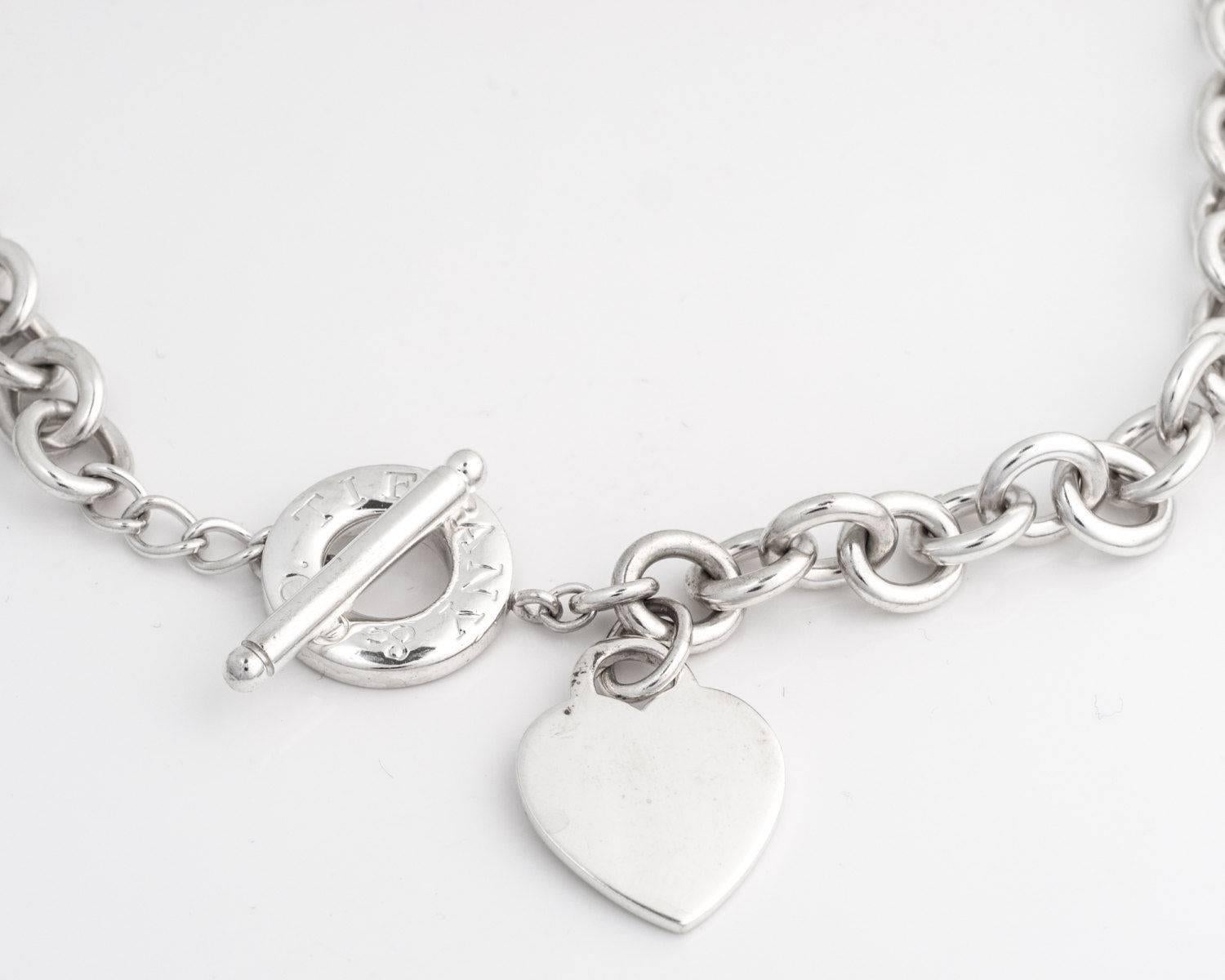 Tiffany and Co. Sterling Silver Heart Tag Toggle Necklace

Features an open link Sterling Silver chain with a Heart Tag charm. The Heart charm can be engraved if you desire. The necklace fastens with a Toggle clasp. 

This beautiful necklace is