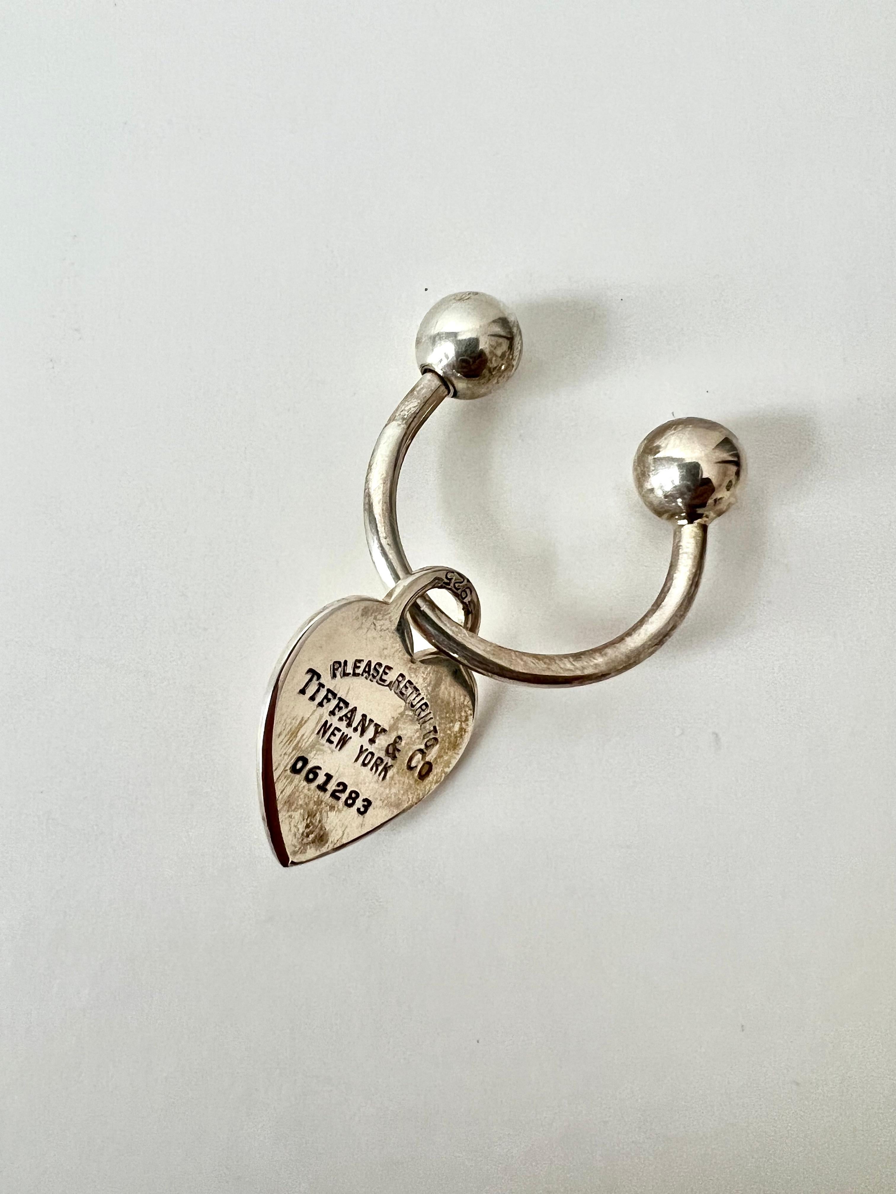 An iconic loop with Ball key chain in Sterling Silver - the piece comes with a sterling heart with return address, if lost, with serial number.  This piece has been engraved PS, which could be removed - 

The two ends are sterling balls, one of