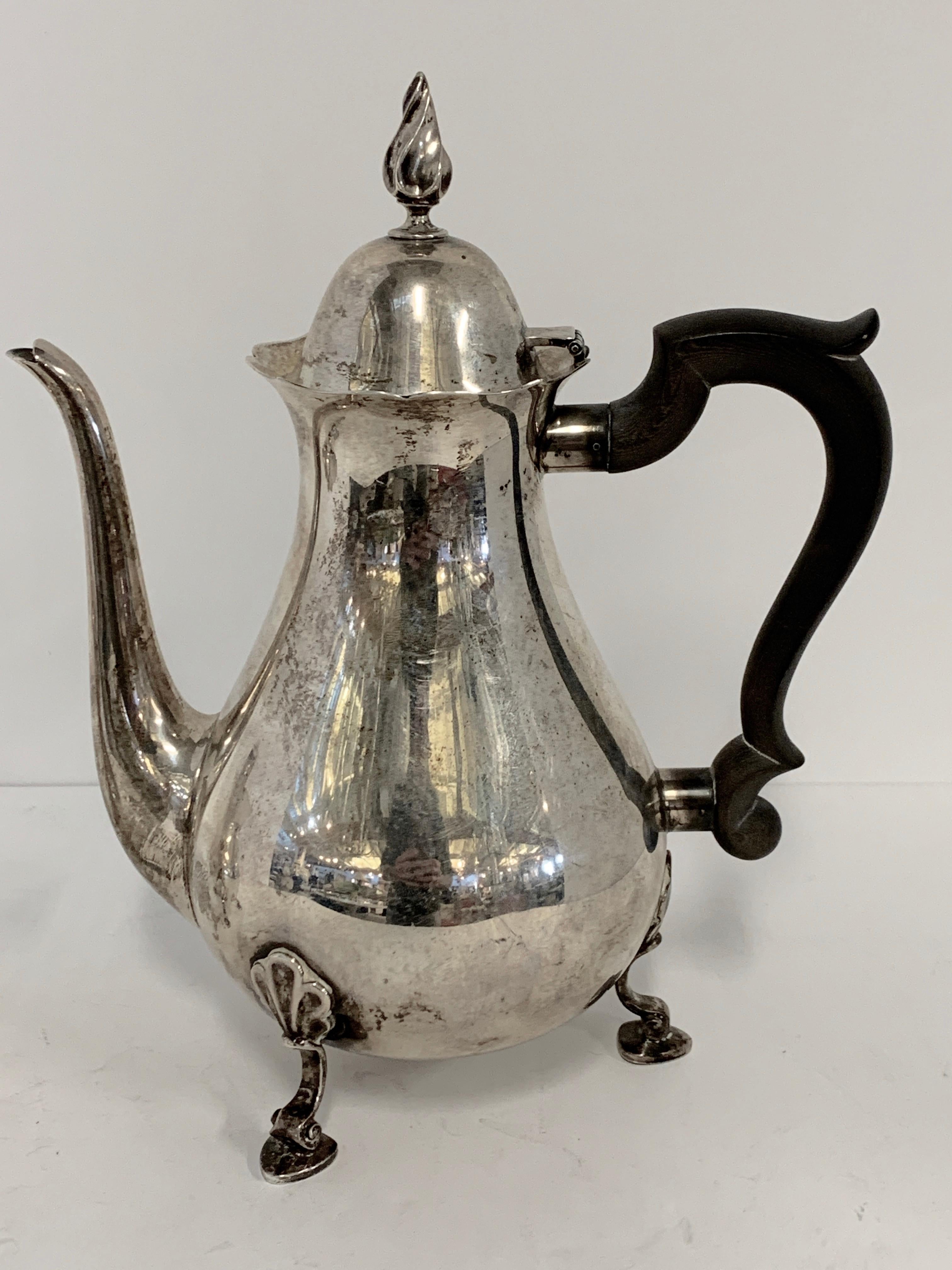 A sterling silver teapot and creamer by Tiffany and Co. makers. Teapot is style number 23750 and also marked 2 pints. The creamer is style 23243. They both feature the same feet. These are not polished at the moment and feature age appropriate wear,