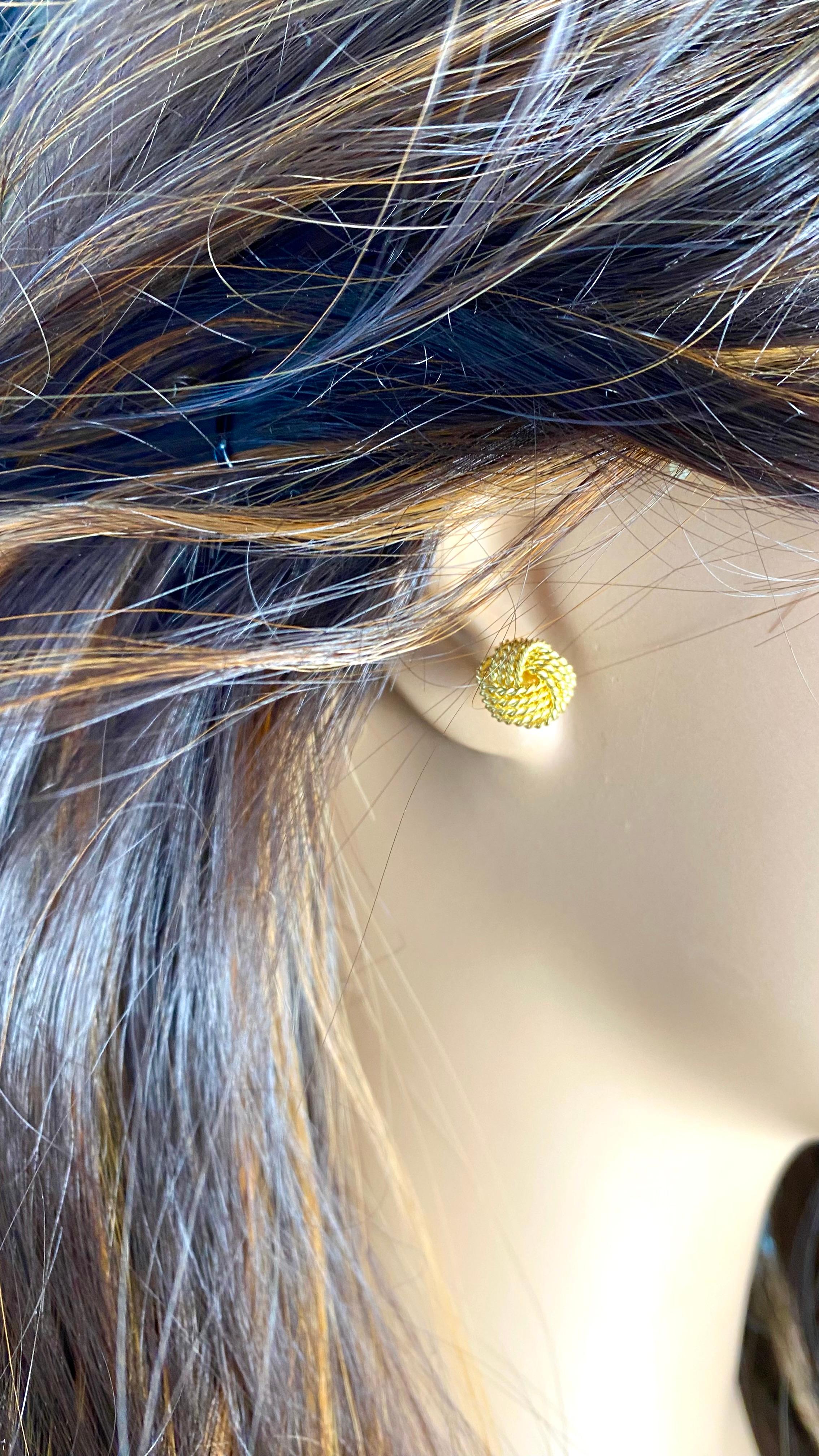 A Timeless Symbol of Unity and Elegance
Elevate your jewelry collection with these exquisite Tiffany & Co. Sterling Silver Yellow Gold Plated Love Knot Stud Earrings. Meticulously crafted by one of the world's most renowned luxury jewelers, these