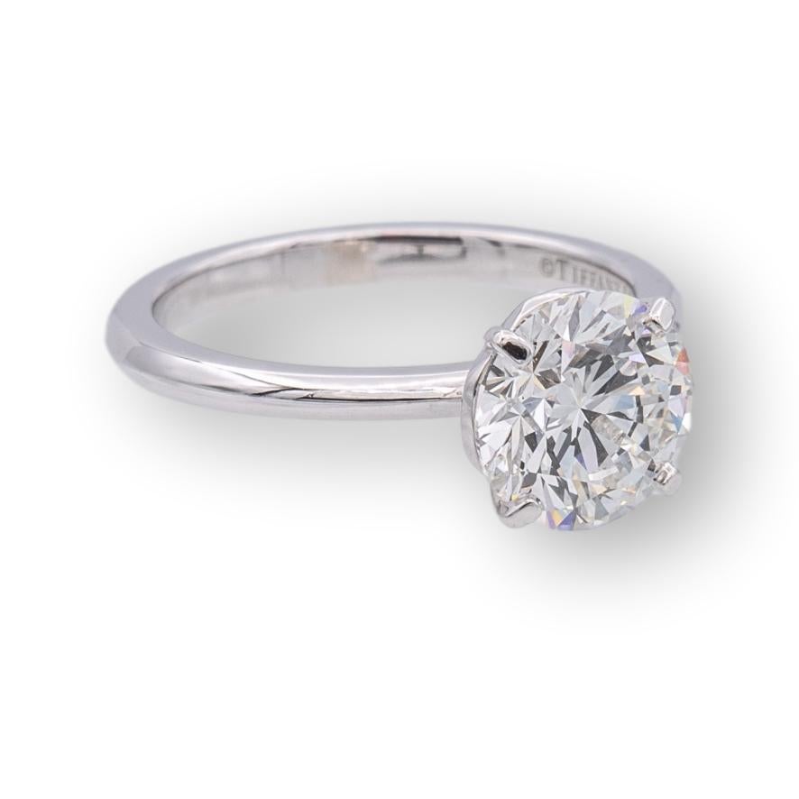 Tiffany & Co. Solitaire Engagement Ring from the True collection finely crafted in platinum featuring a round brilliant cut diamond center weighing 1.37 cts total weight   H color, VVS1 clarity with excellent cut , polish and symmetry set in a 4