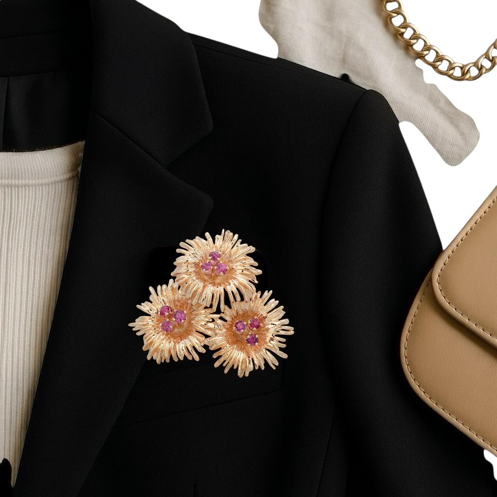 This exquisite Tiffany & Co. floral design pin is crafted from 14KT yellow gold, offering a timeless and elegant piece of fine jewelry. The pin features nine small, round, vivid rubies with a total weight of approximately 1.20 carats, meticulously