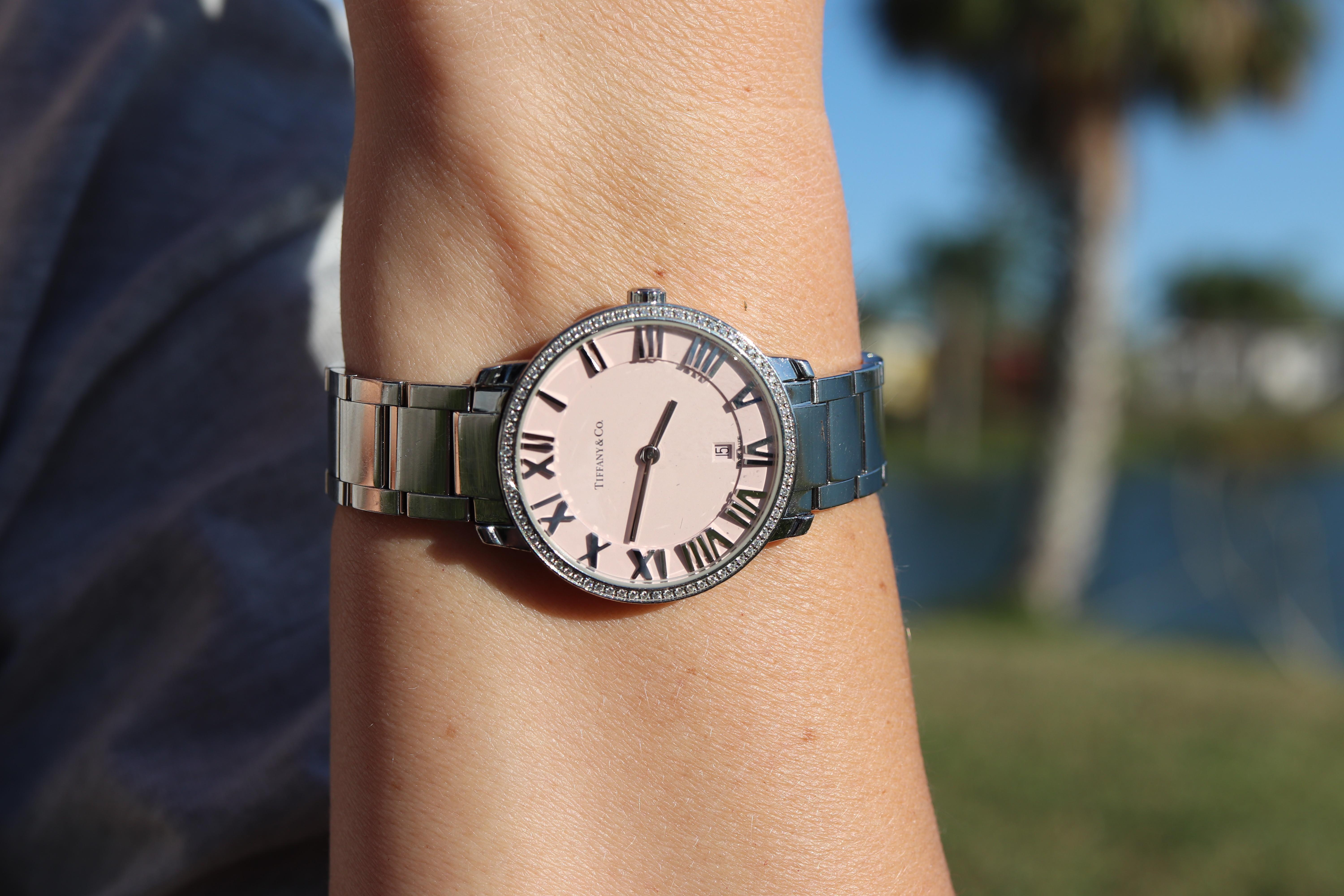 Tiffany and Co Atlas Watch
Diamond Bezel with Pink Dial and Calendar

Stainless Steel with Diamonds
31mm case

Beautiful Ladies Watch.


Condition: Excellent Condition

6.5in wrist.