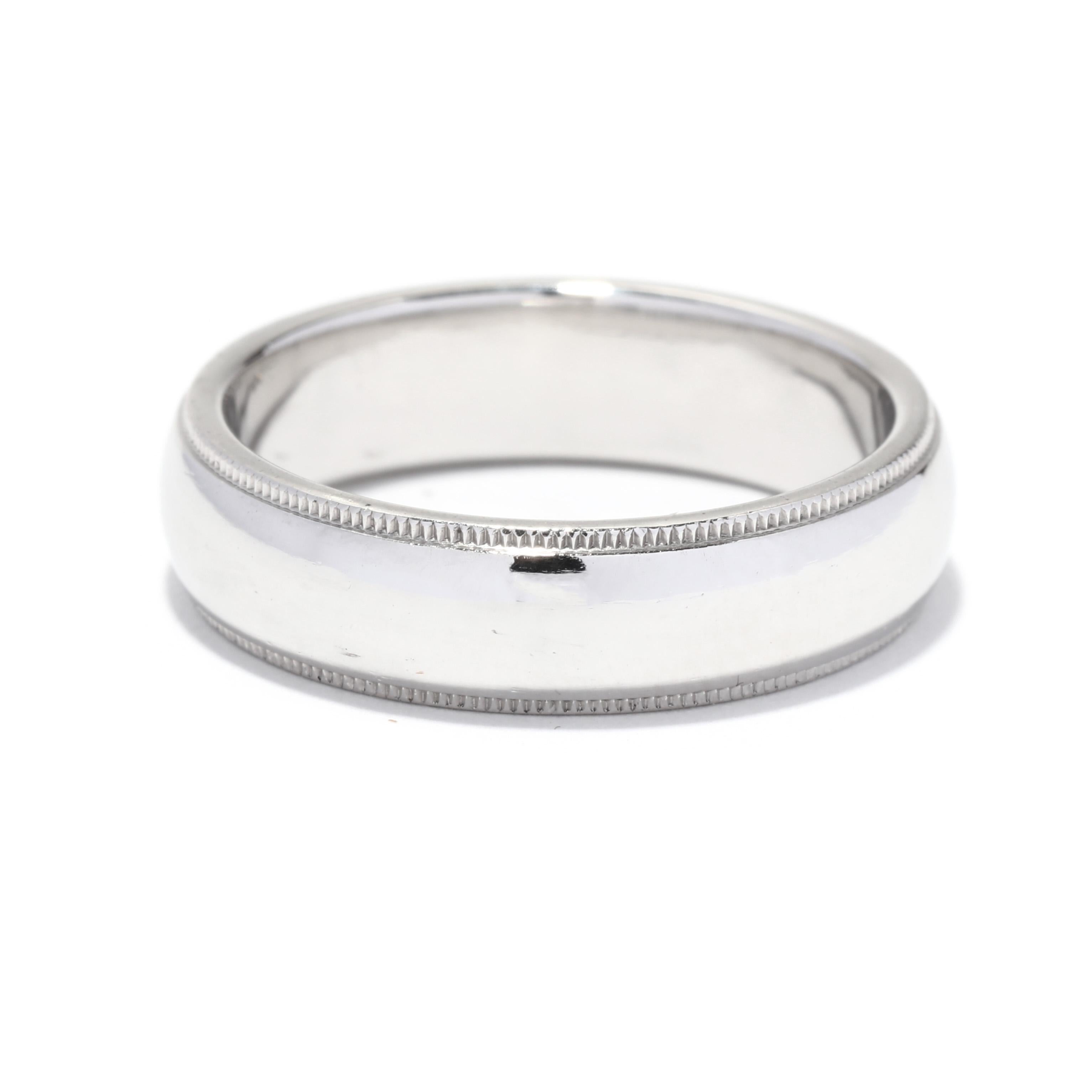 A vintage Tiffany and Company classic milgrain platinum wedding band. This wide gent's band features a slightly domed design with milgrain detailing in an eternity design.

Ring Size 10

Width: 6 mm

Weight: 9.6 dwts. / 14.93 grams

Stamps: TIFFANY