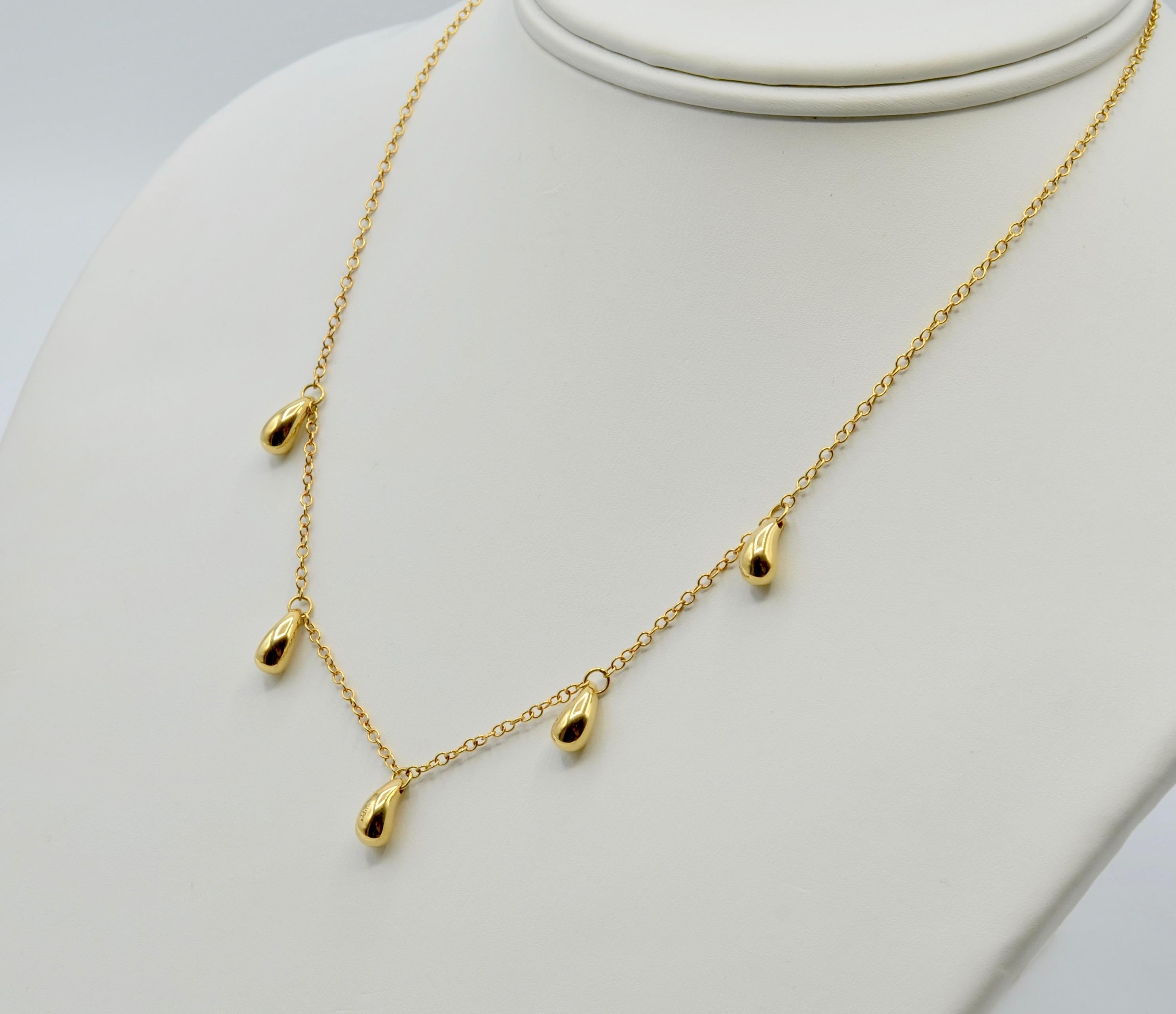 This iconic Elsa Peretti necklace is a beautiful halo around your neck. The 'beans' are solid gold and have a nice weight to them. You can wear it alone or layer with your other favorite pieces. The 16