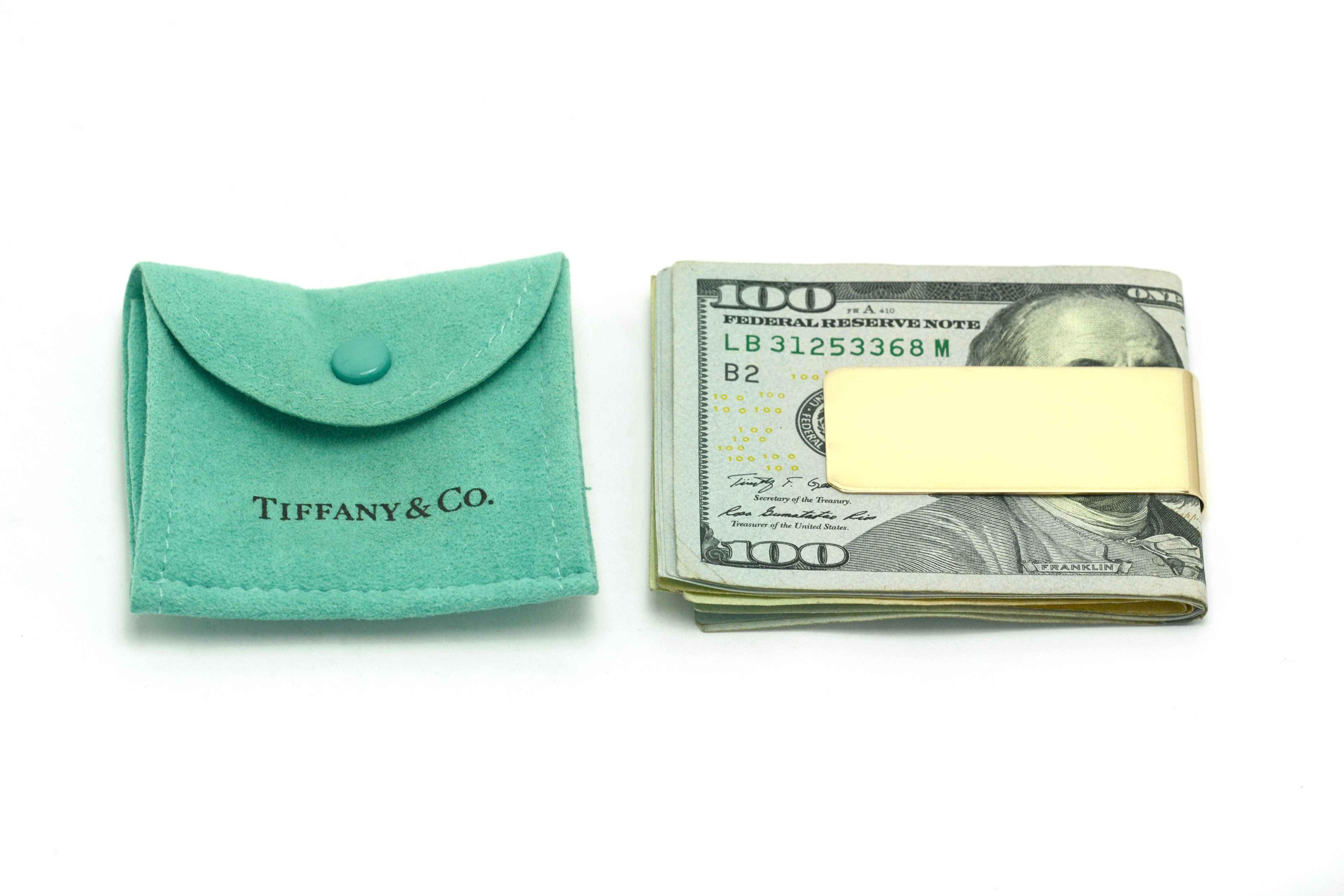 This Tiffany and Company money clip is a classic design from the iconic design house. A vintage, estate heirloom crafted of solid, heavy 14k gold weighing in at over 2/3 ounce is in very good condition and will hold a nice wad of cash and cards