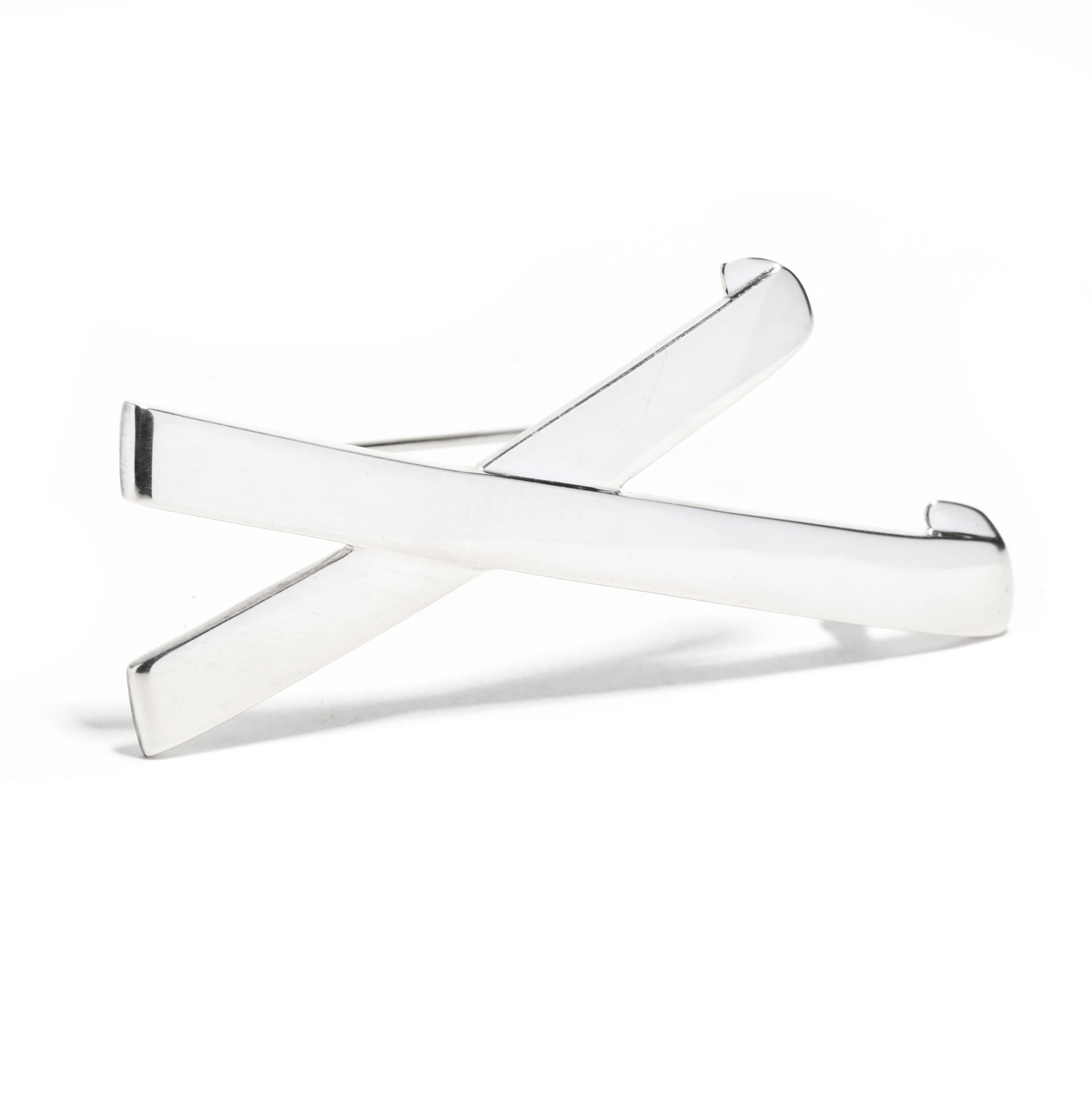 A Tiffany and Company Paloma Picasso sterling silver graffiti X brooch. This large silver brooch features a flat, overlapping X motif with a pin stem and C clasp.

Length: 2.5 in.

Width: 1 1/8 in.

Weight: 7.8 dwts. / 12.1 grams

Stamps: 1985
