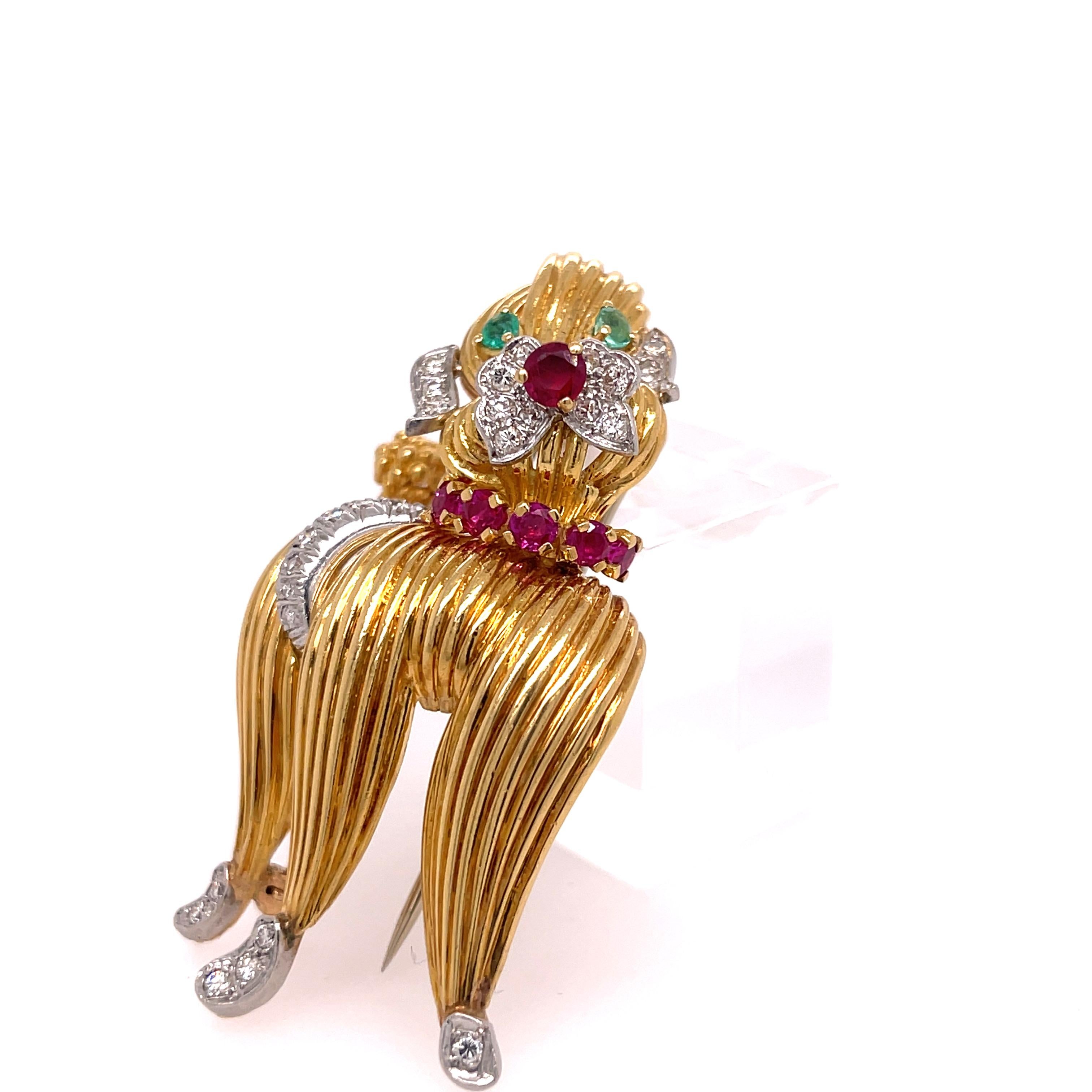 Poodle Pin from Tiffany and Company.  18K Yellow Gold Diamond, Ruby and Emerald Eyes!
One inch by 2 inches.  Stamped 18K Tiffany & Co.
