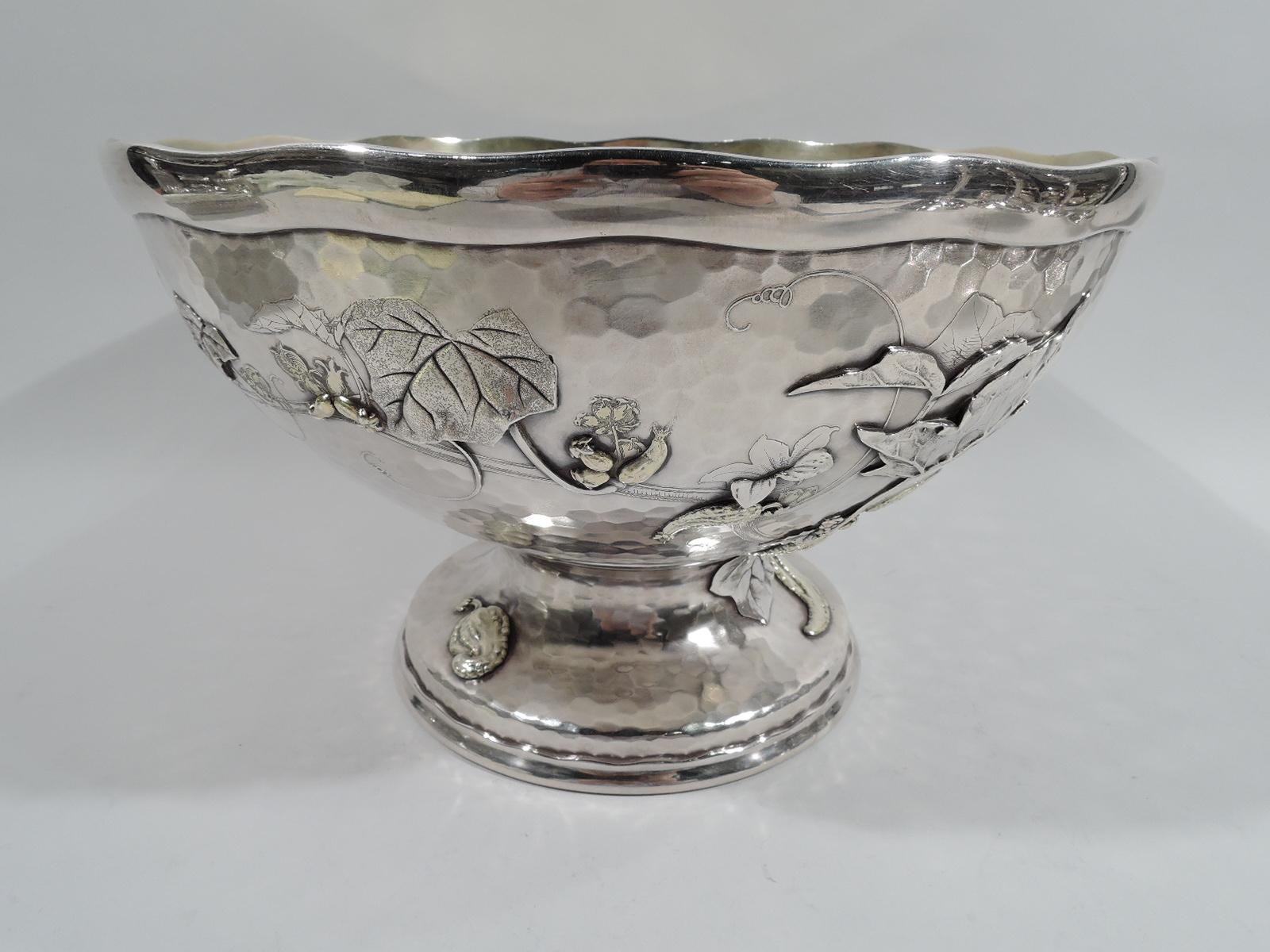 Japonesque sterling silver centerpiece bowl. Made by Tiffany & Co. in New York, ca 1877. Hemispheric with wavy rim; round and stepped foot. Exterior has applied and acid-etched ornament heightened with gilding and engraving: Leafing branches with