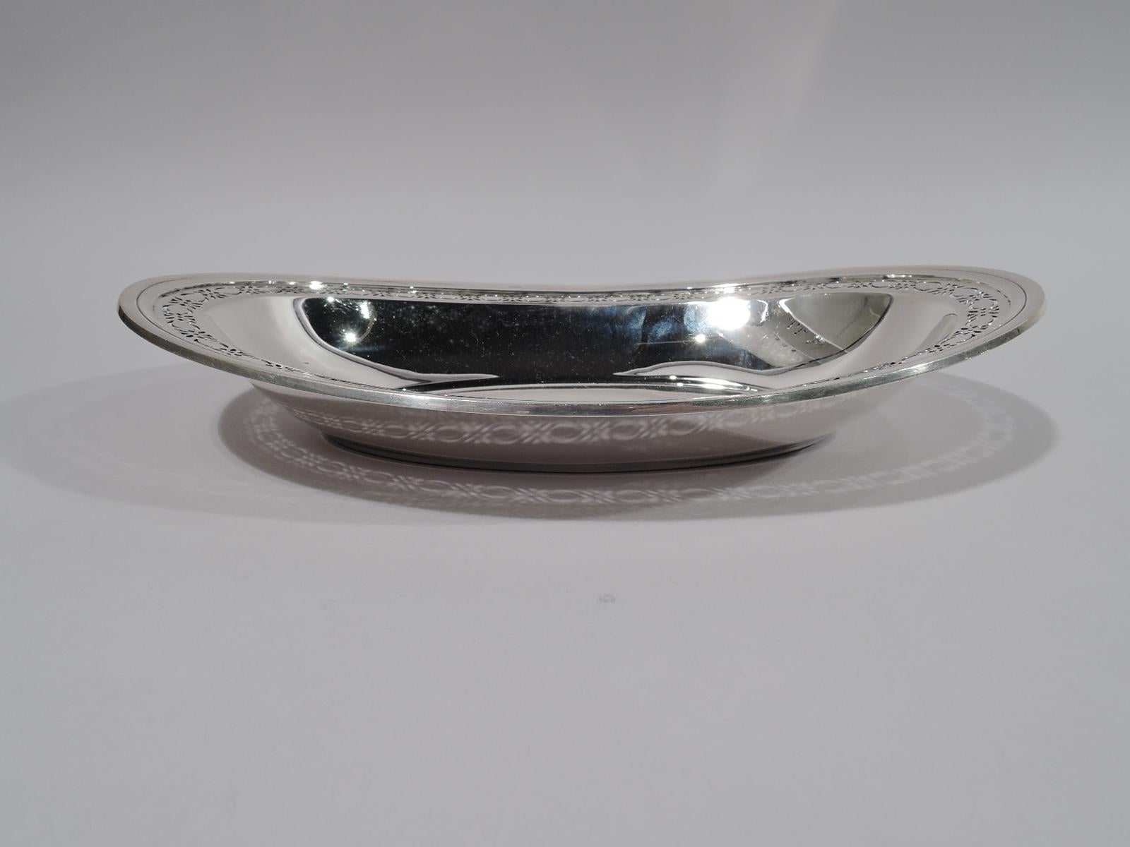 Art Deco sterling silver bread tray. Made by Tiffany & Co. in New York, circa 1925. Boat-form oval with pierced semi-abstract floral border. Spare ornament and nice heft. Fully marked including director’s letter m and pattern no. 20600K (first