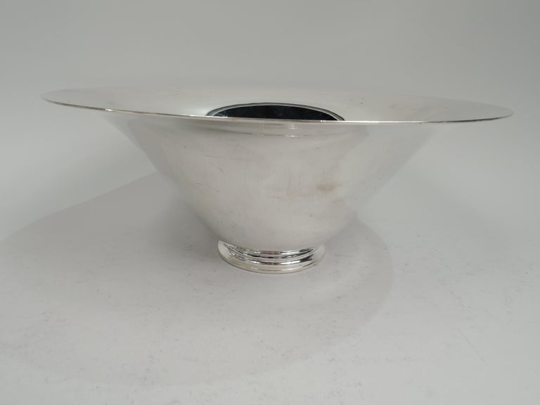Art Deco sterling silver centerpiece bowl. Made by Tiffany & Co. in New York, ca 1924. Tapering sides with wide mouth and flared rim on stepped foot. A dramatic and fluid centerpiece. Fully marked including maker’s stamp, pattern no. 20448 (first