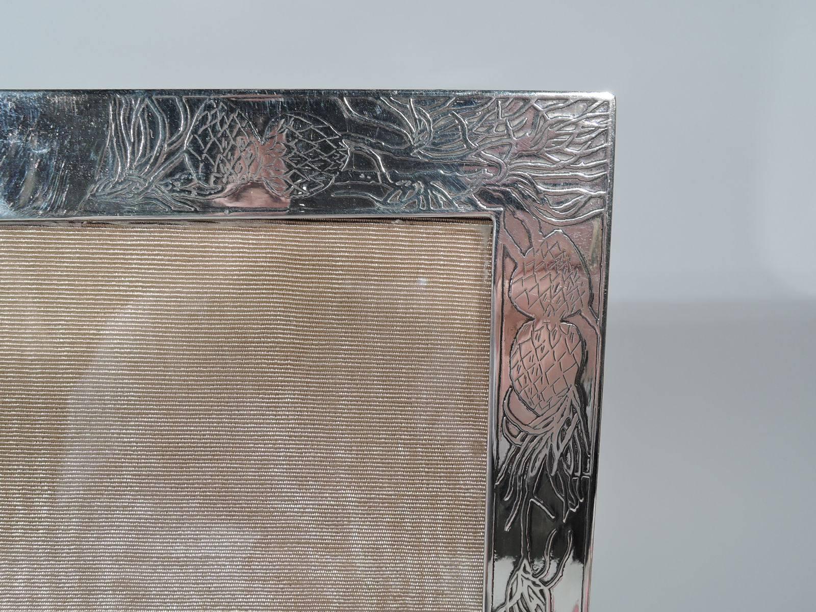 Art Nouveau sterling silver picture frame. Made by Tiffany & Co. in New York. Rectangular window with acid-etched surround and sides: Hallucinatory, semi-abstract ornament in form of vegetation joined by dense and interlaced tendrils. With glass,