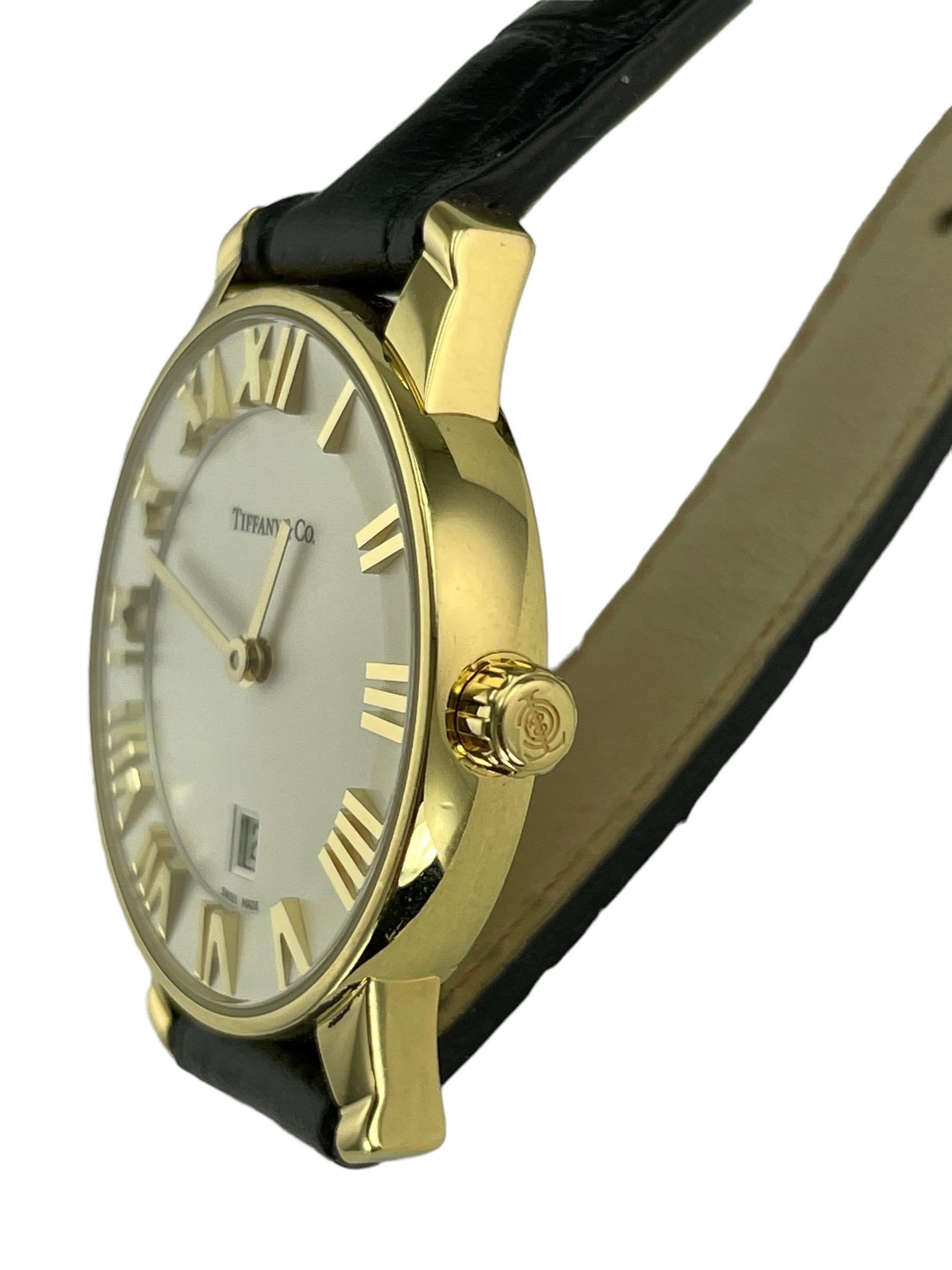 Tiffany Atlas yellow gold quartz wristwatch.

ABOUT THIS ITEM: Tiffany Atlas 18k yellow gold quartz wristwatch with leather strap, from the late 1990s.

SPECIFICATIONS: DJ92C

METAL: 18k yellow gold.

MEASUREMENTS: 29mm

CONDITION: high