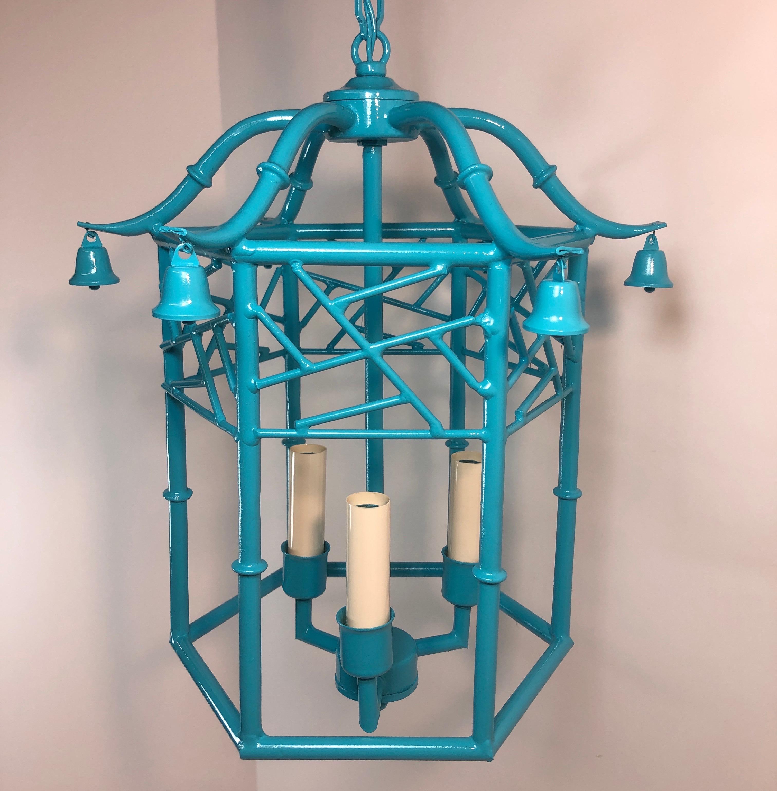 Tiffany blue faux bamboo pagoda chandelier, adorned with bells. Three sockets. Matching ceiling cap, ready to hang. Newly painted. Height without chain is 15