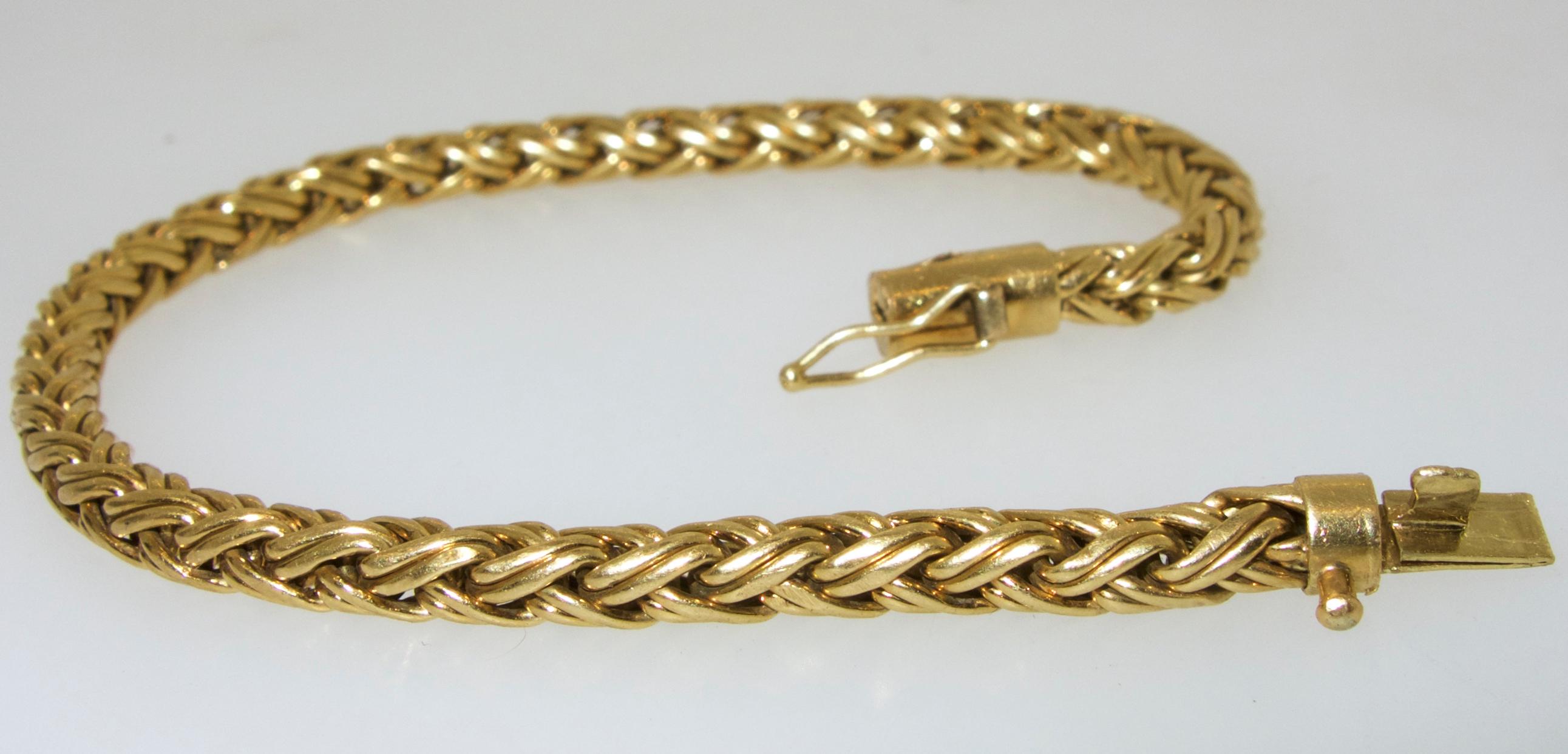 Tiffany & Co. 18K gold bracelet in a woven link.  7 inches long, signed on the clasp with 750 for 18K.  This bracelet weighs 10.8 grams.