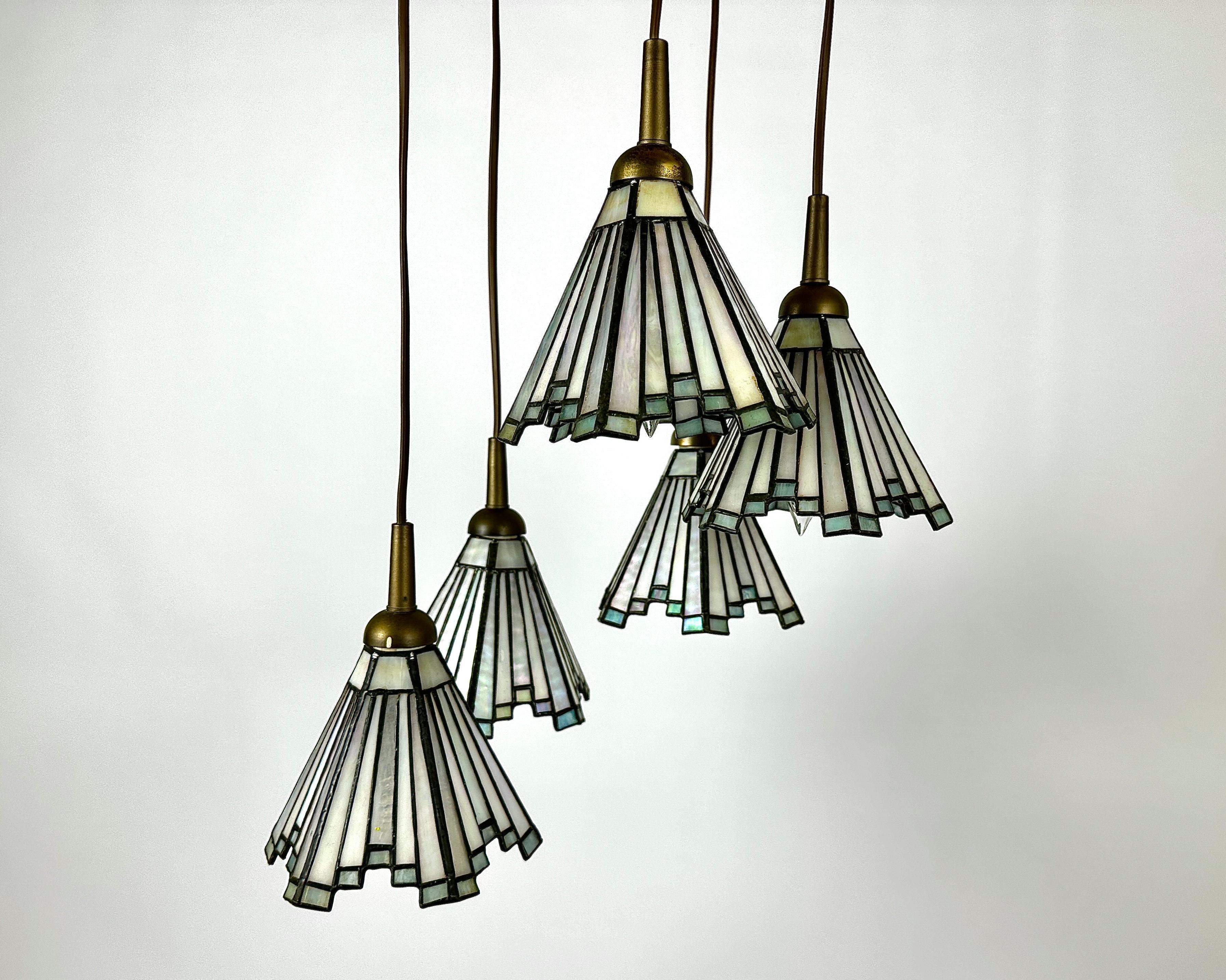 This Tiffany brass pendant lights by Honsel Lighting is a version of this favorite, combining the elegance of the Tiffany light with a sleek and more compact design you can hang almost anywhere.

Manufactured in Germany, in 1960s.

This pendant is