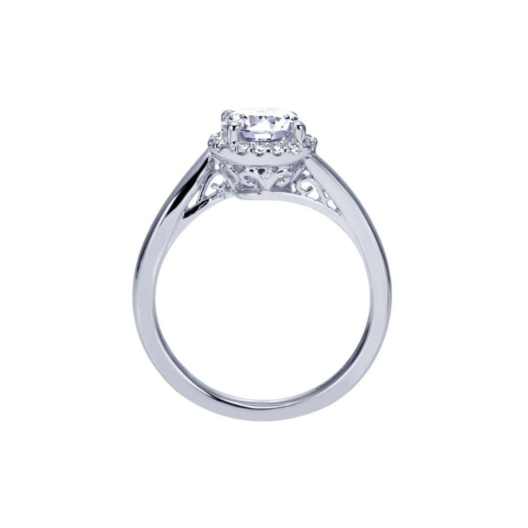 Ladies' 14k Tiffany Bypass Diamond Engagement Mounting. Clean lines with a twist on a classic Tiffany halo style. Delicate filigree work underneath the halo adds subtle sophistication. Center diamond NOT included. Side diamonds are 0.11 ctw, H