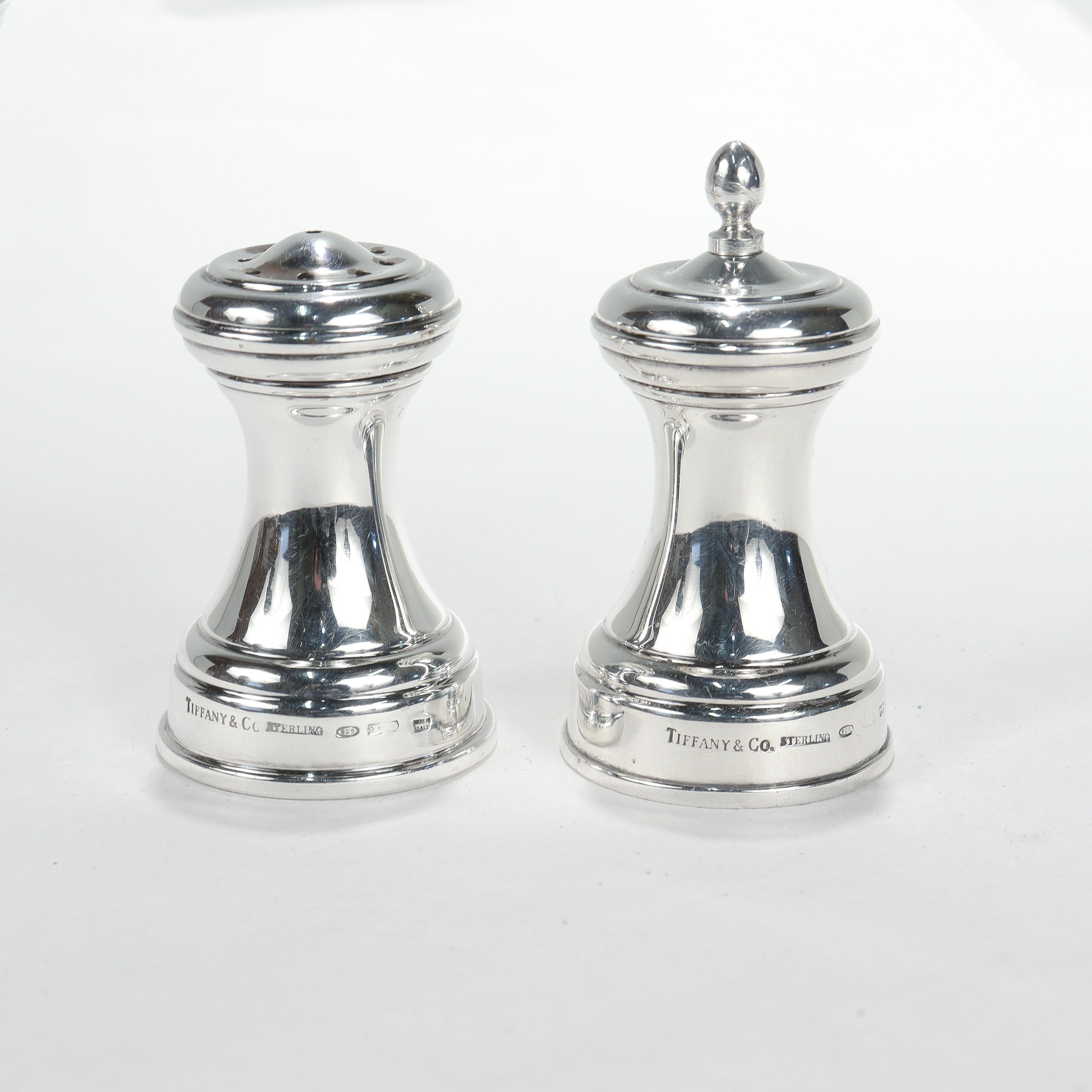 A fine pair of silver salt and pepper shakers.

By Tiffany & Co.

In sterling silver.

In the Capstan pattern. 

The salt shaker is stamped Tiffany & Co. / Sterling / 925 / Made in Italy / and with Italian hallmarks. The pepper grinder is marked to