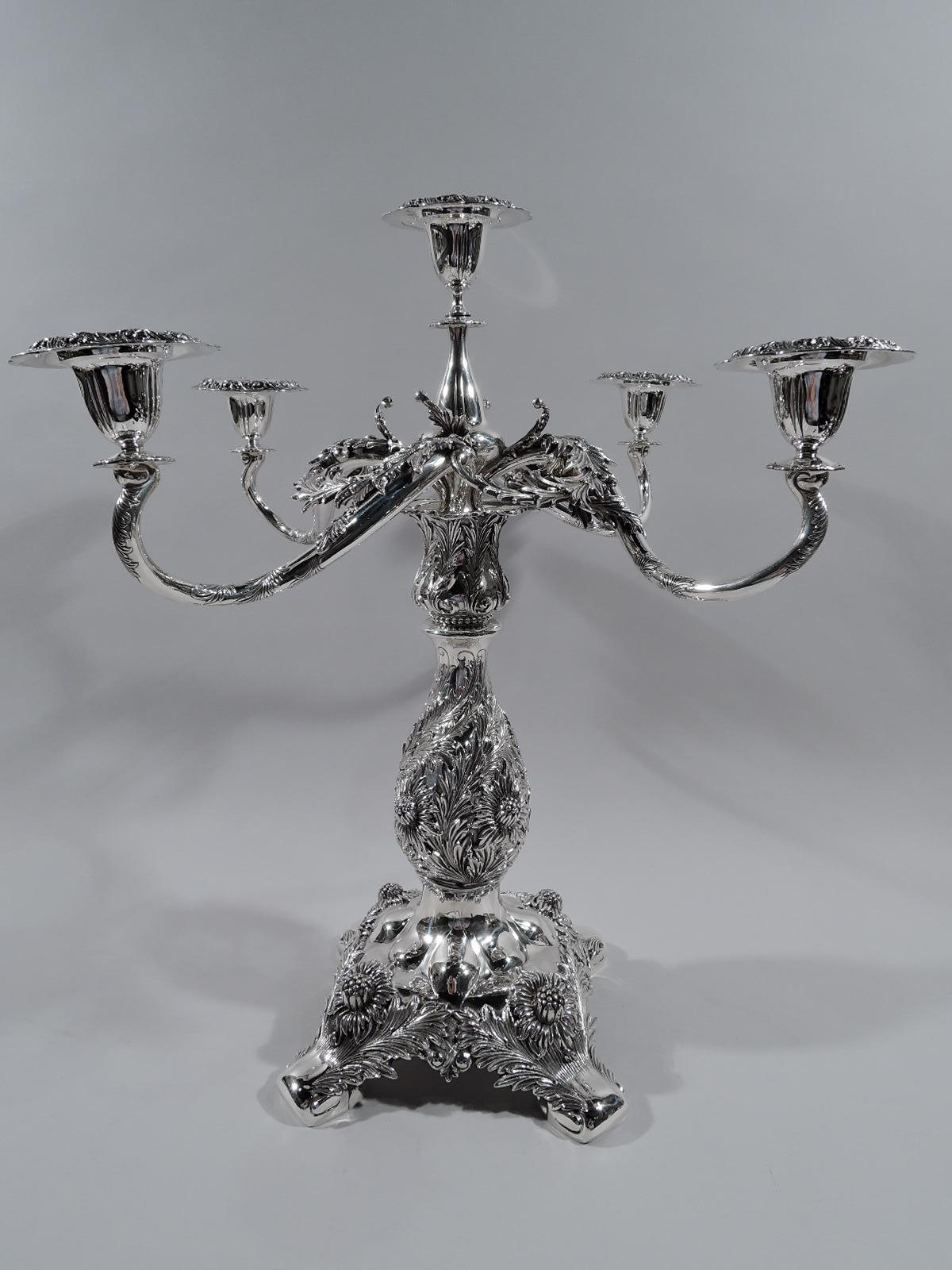Chrysanthemum sterling silver 5-light centerpiece candelabrum. Sizable baluster shaft on raised squarish foot with corner volute supports. Four scrolled arms, each terminating in single socket, joined by applied leaves and surrounding central raised