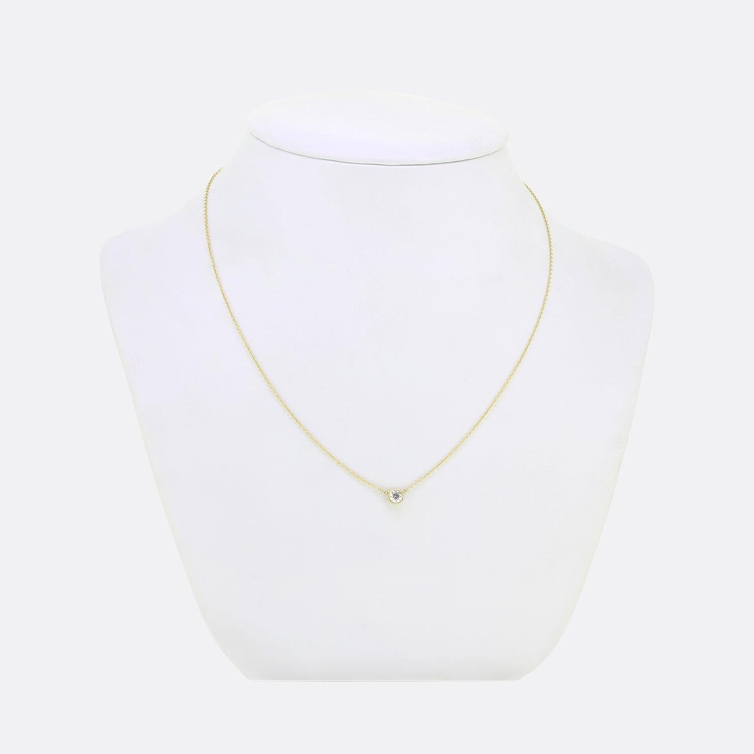 Here we have simple yet elegant necklace from the world renowned jewellery designer, Tiffany & Co. A single hand-polished diamond which shines at the centre of a delicate and refined rub-over setting hangs from a slim signed 18ct yellow gold belcher
