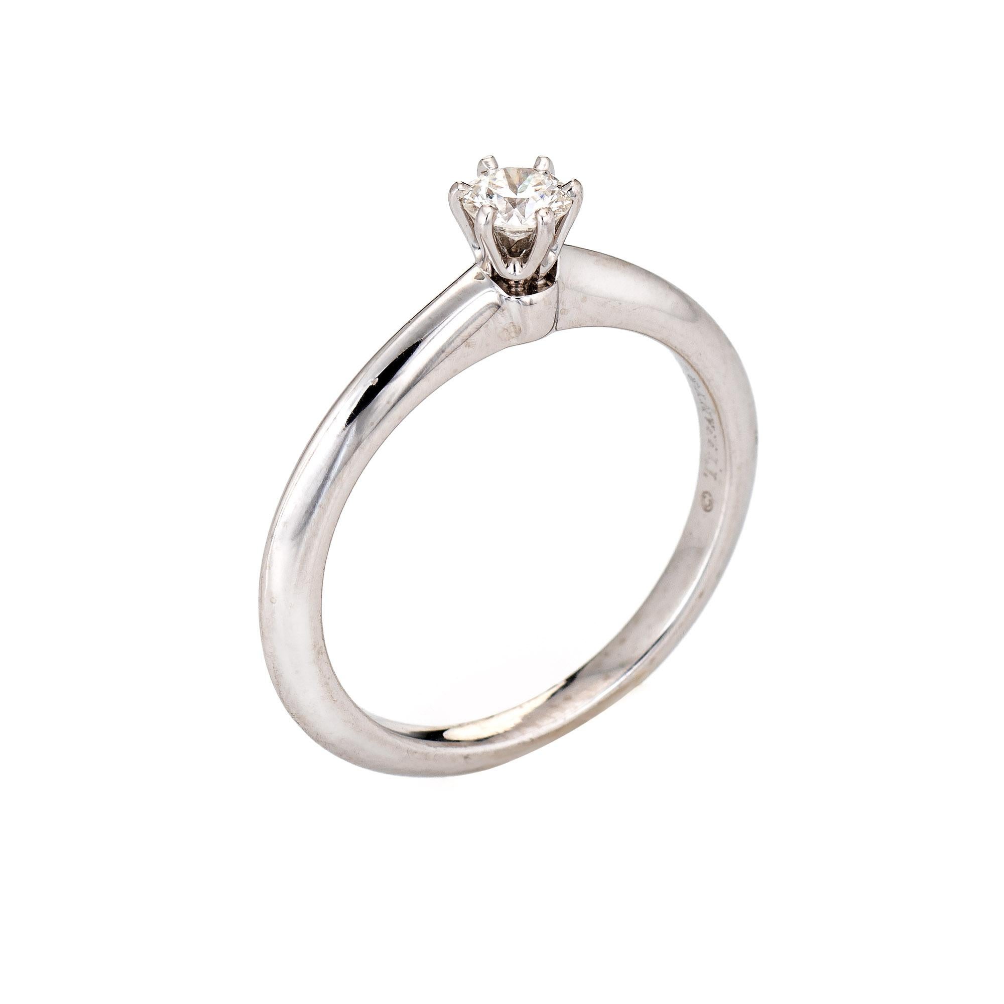 Estate Tiffany & Co diamond solitaire engagement ring crafted in platinum (circa 2000s).  

Round brilliant cut diamond is 0.19 carats (estimated at F-G color and VVS2 clarity).

The Tiffany ring features a diamond solitaire set into the classic