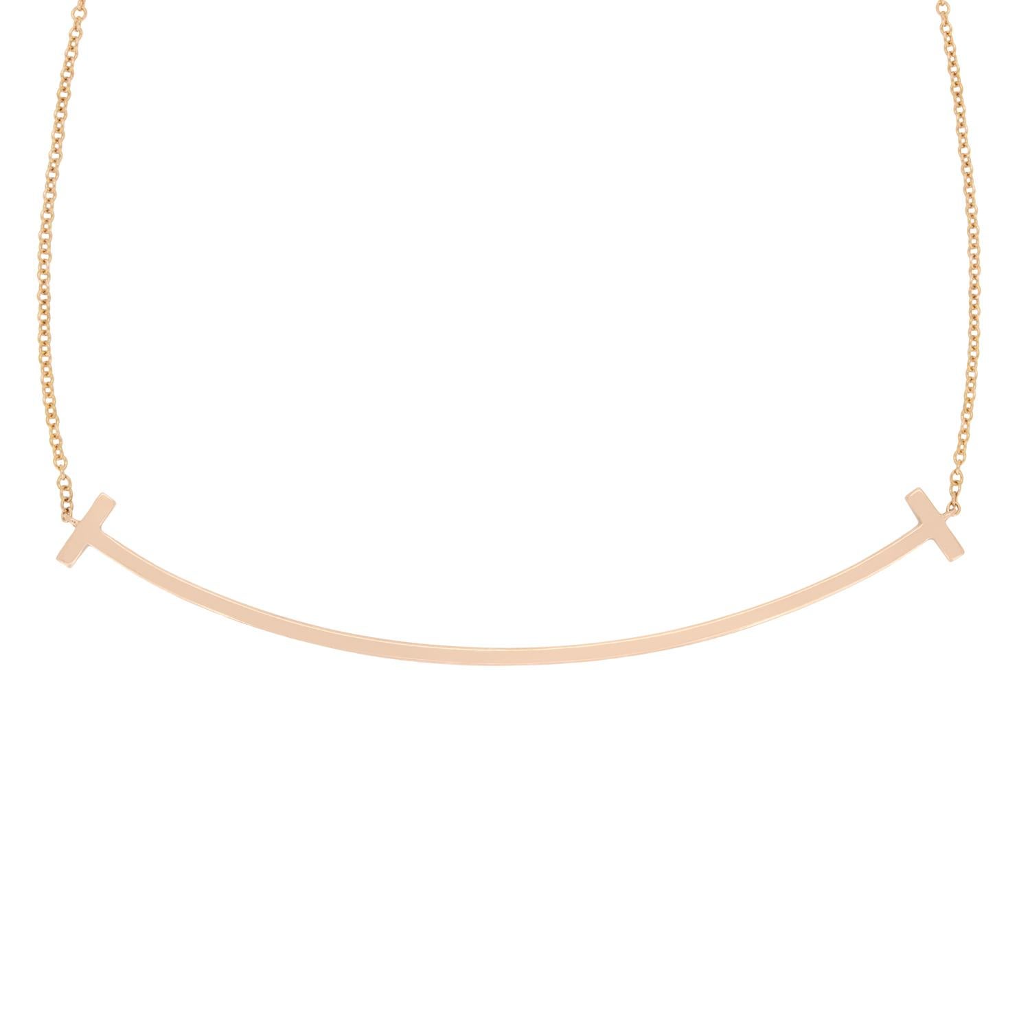 This wonderful pendant from Tiffany & Co. is from their iconic Tiffany T collection. The 18 carat rose gold piece is the large version of the pendant and features grain set diamonds across the entirety of the front, totalling 0.19 carat. The diamond