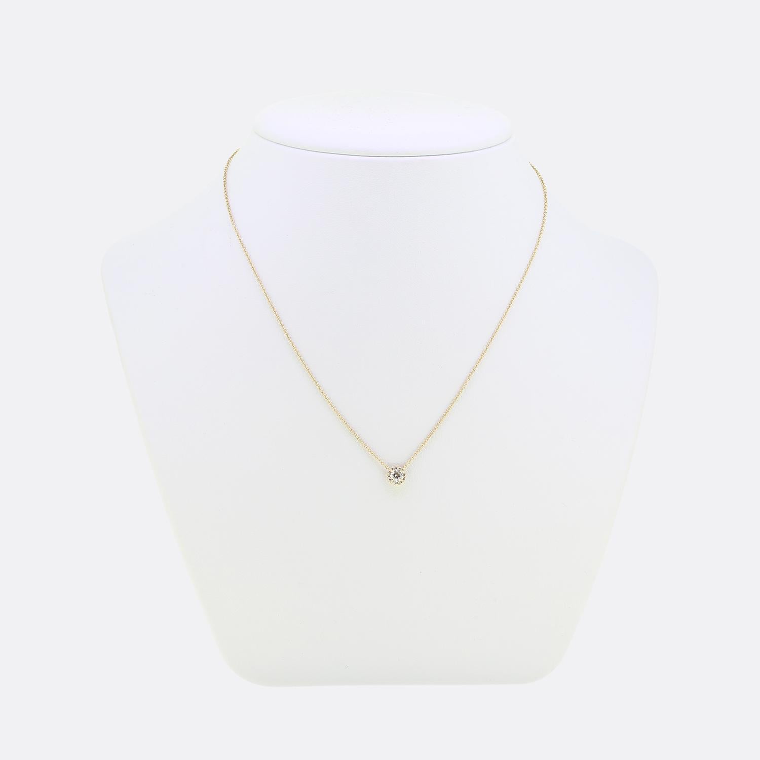 Here we have simple yet elegant necklace from the world renowned jewellery designer, Tiffany & Co. A single hand-polished brilliant cut diamond which shines at the centre of a four-clawed setting is framed by a halo of 12 smaller matching diamonds