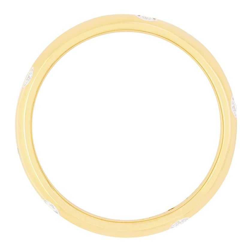 A classic design from Tiffany & Co., this band ring comes from the ‘Etoile’ collection. The ring is crafted in 18 carat yellow gold with a collection of round brilliant diamonds, rub over set into platinum  across its length. The diamonds total 0.22