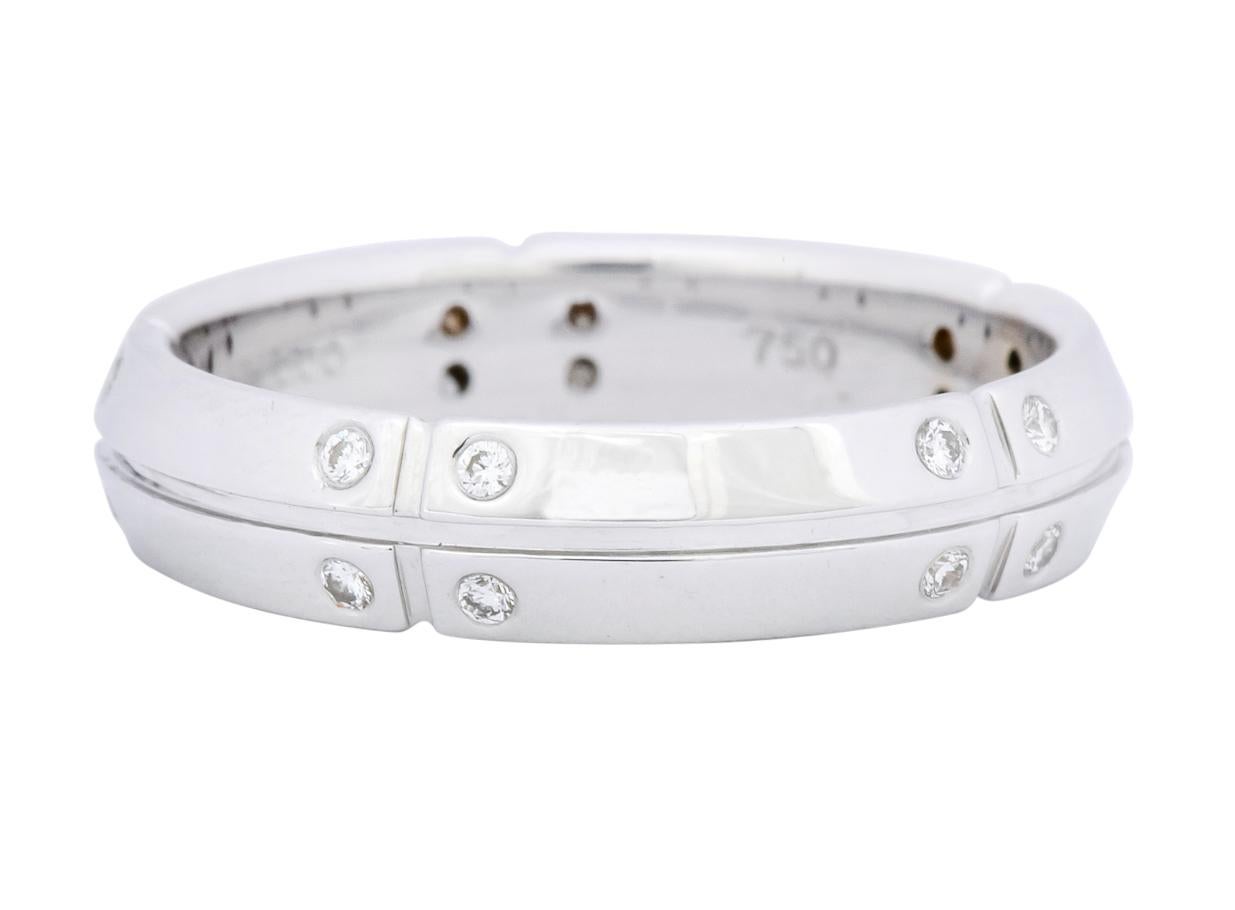Brushed white gold with twenty round brilliant cut diamonds, flush set, weighing approximately 0.30 carats total, G color and VS clarity

With polished gold grooves and a knife-edge style band

Fully signed Tiffany & Co. and dated 2000 

Streamerica