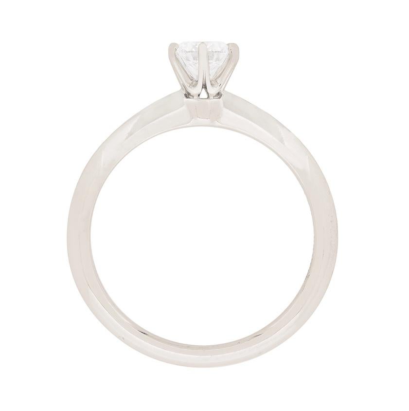 A Tiffany & Co. icon, set in the jeweller’s time-honoured, six claw, knife-edge setting with a lively 0.30 carat round brilliant cut diamond. Beautifully cut, the diamond has been graded to a desirable VVS2 clarity, with its F colour emphasised by