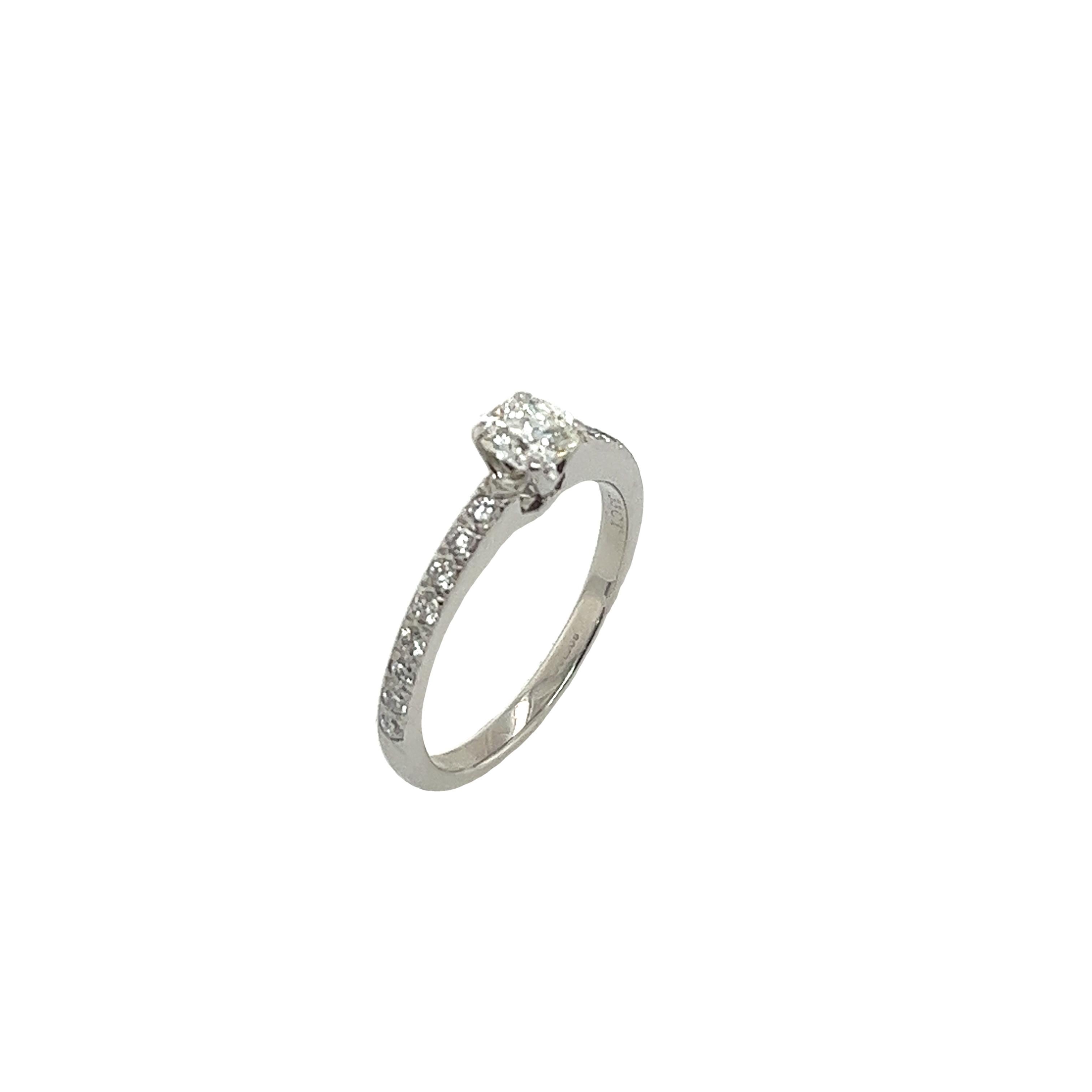 Discover elegance and sophistication with the Tiffany & Co 0.33ct Square Cushion Diamond Engagement Ring. This timeless piece features a brilliant 0.33-carat diamond set in platinum with additional diamonds on the shoulders, symbolizing eternal love