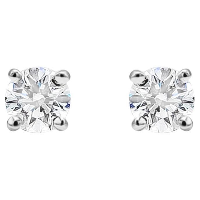 This simple and classic style of stud earrings showcasing a pair of round brilliant diamonds weighing 0.36 carats total, F Color and VS1+ in Clarity. Set in a classic four-prong setting, threaded post, made in Platinum. Made and Signed by Tiffany &