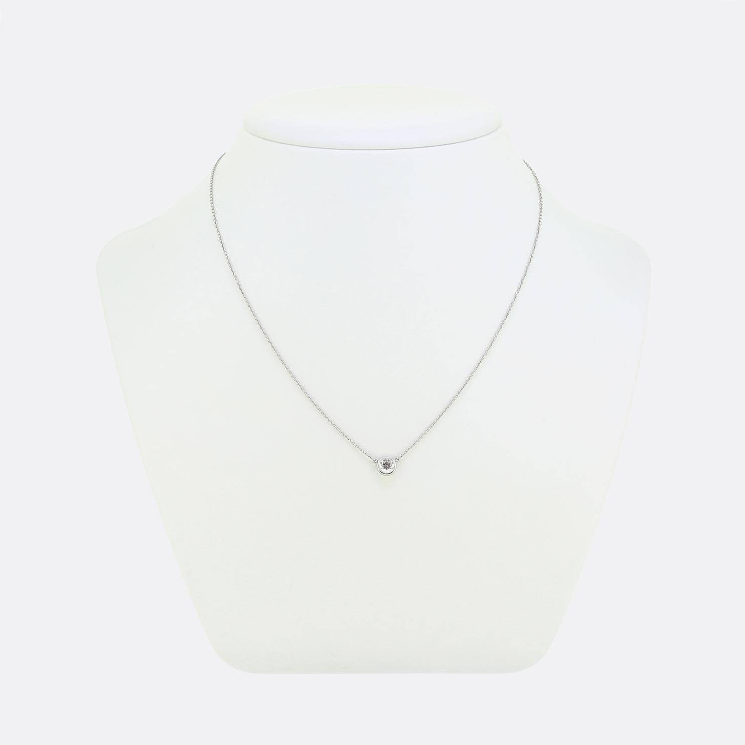 Here we have a platinum solitaire necklace from the world renowned jewellery designer, Tiffany & Co. This piece features a single bright white round brilliant cut diamond set in a sleek bezel setting to create a minimalist yet elegant focal point.