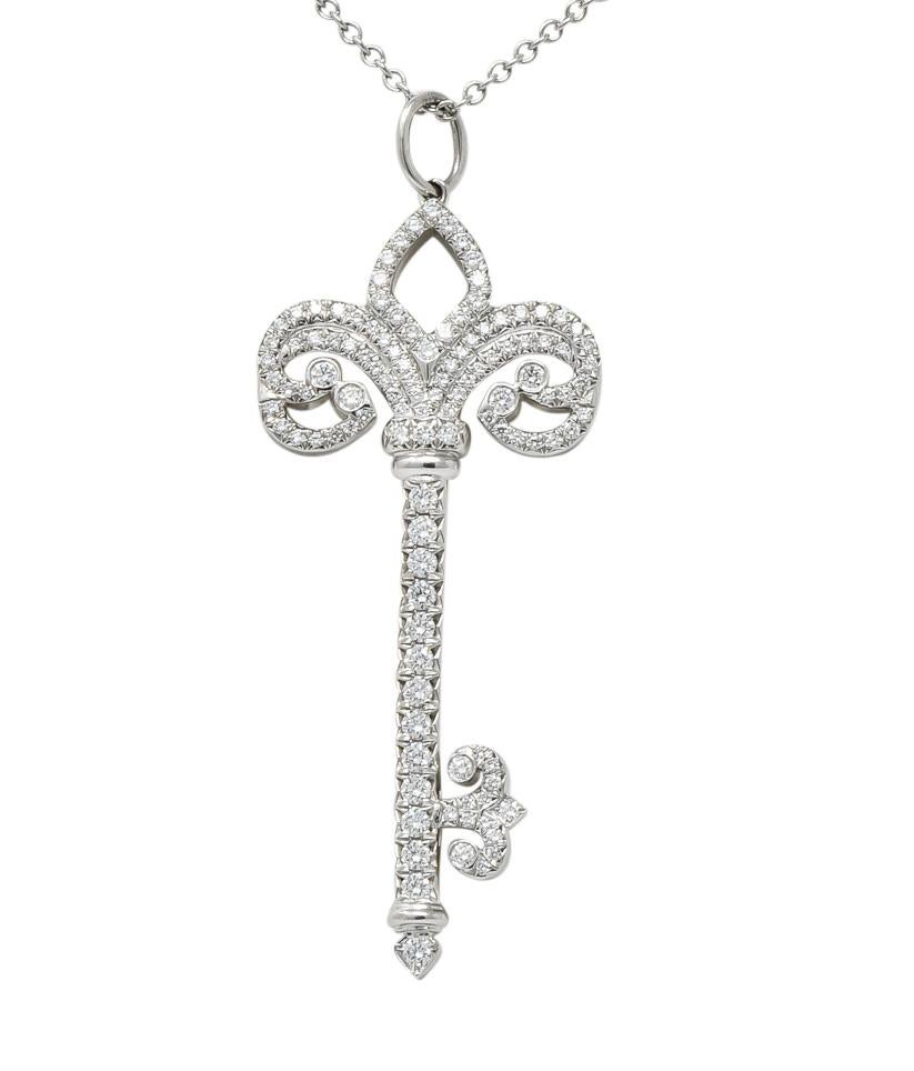 Pendant designed as skeleton style key with head as a scrolling fleur de lis motif

Set throughout with round brilliant cut diamonds weighing approximately 0.55 carat total, F/G color and VS clarity

Accompanied by platinum cable chain completed by