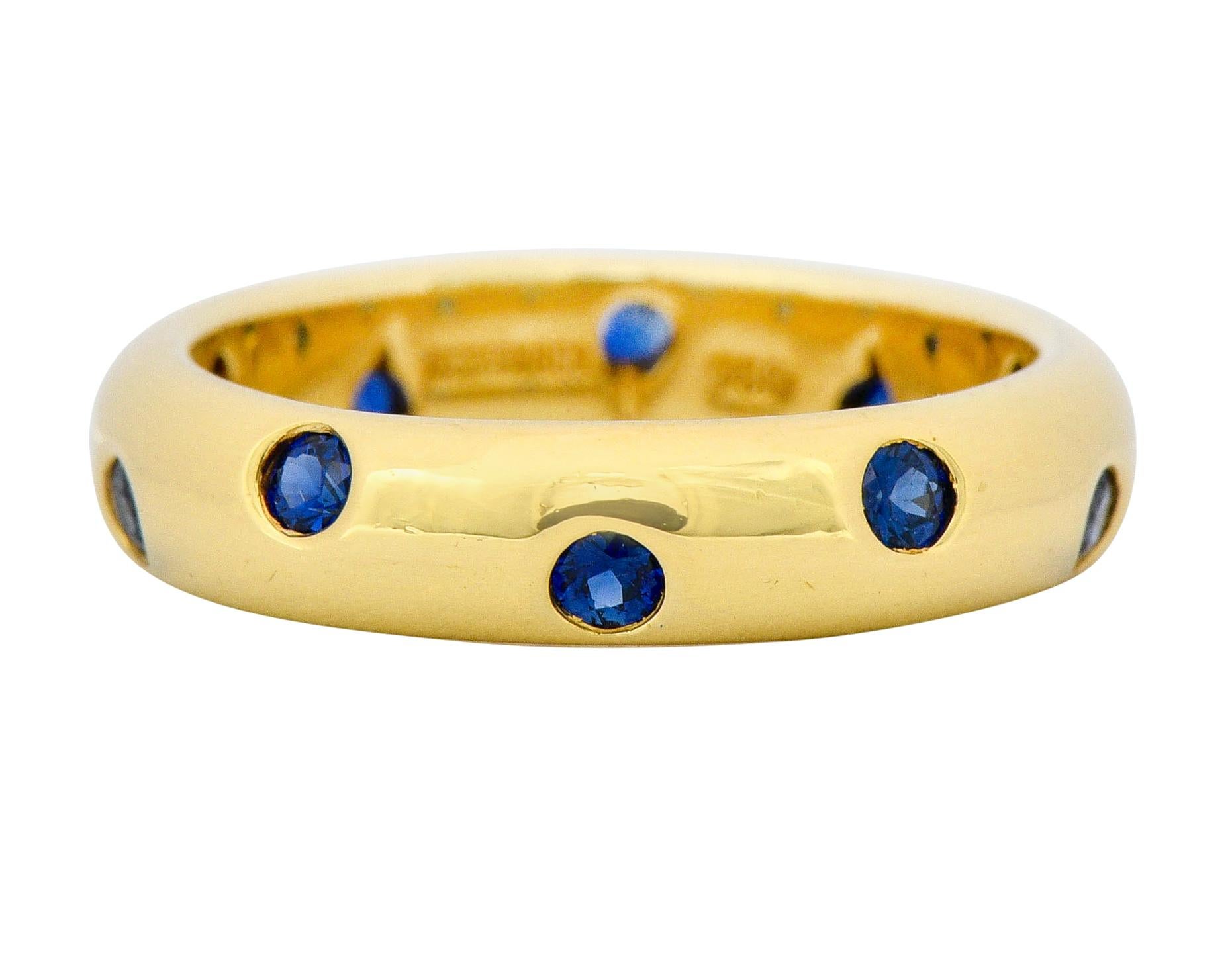 Band style ring with a high polished finish and a rounded curvature

Flush set throughout by ten round cut sapphire weighing approximately 0.40 carat total

Very well-matched with a bright medium-dark royal blue color

Fully signed Tiffany & Co. and