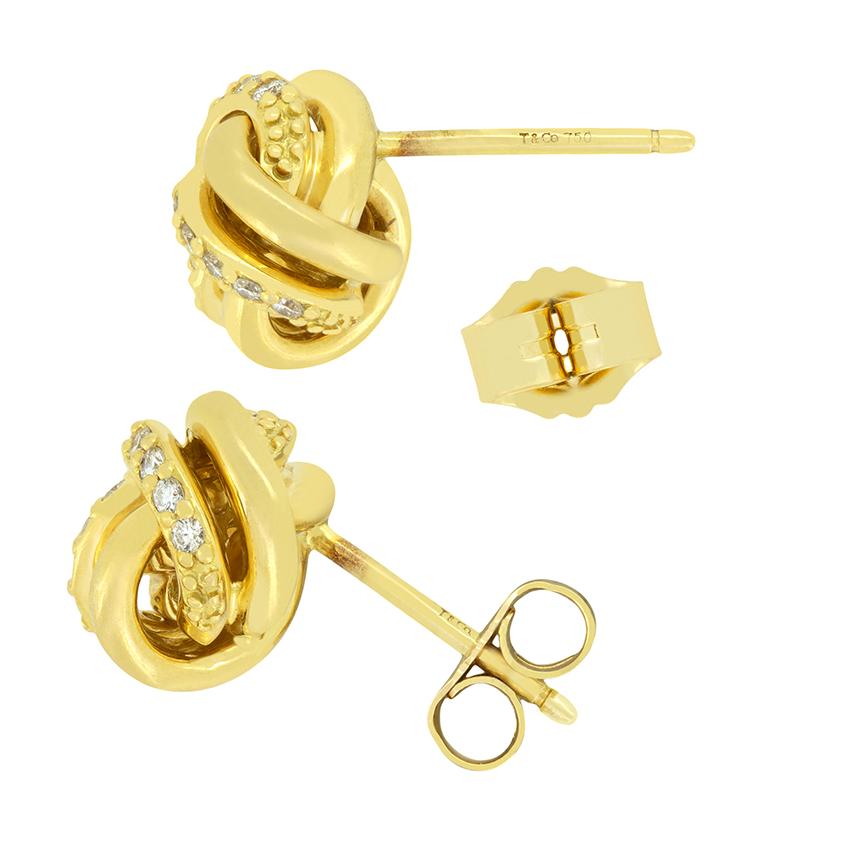 From the designer Tiffany & Co. comes this delightful pair of Love Knot Earrings. Crafted in 18 carat yellow gold the knotted rope design is adorned by twenty-one small diamonds. These diamonds total 0.42 carat and are of exceptional quality,